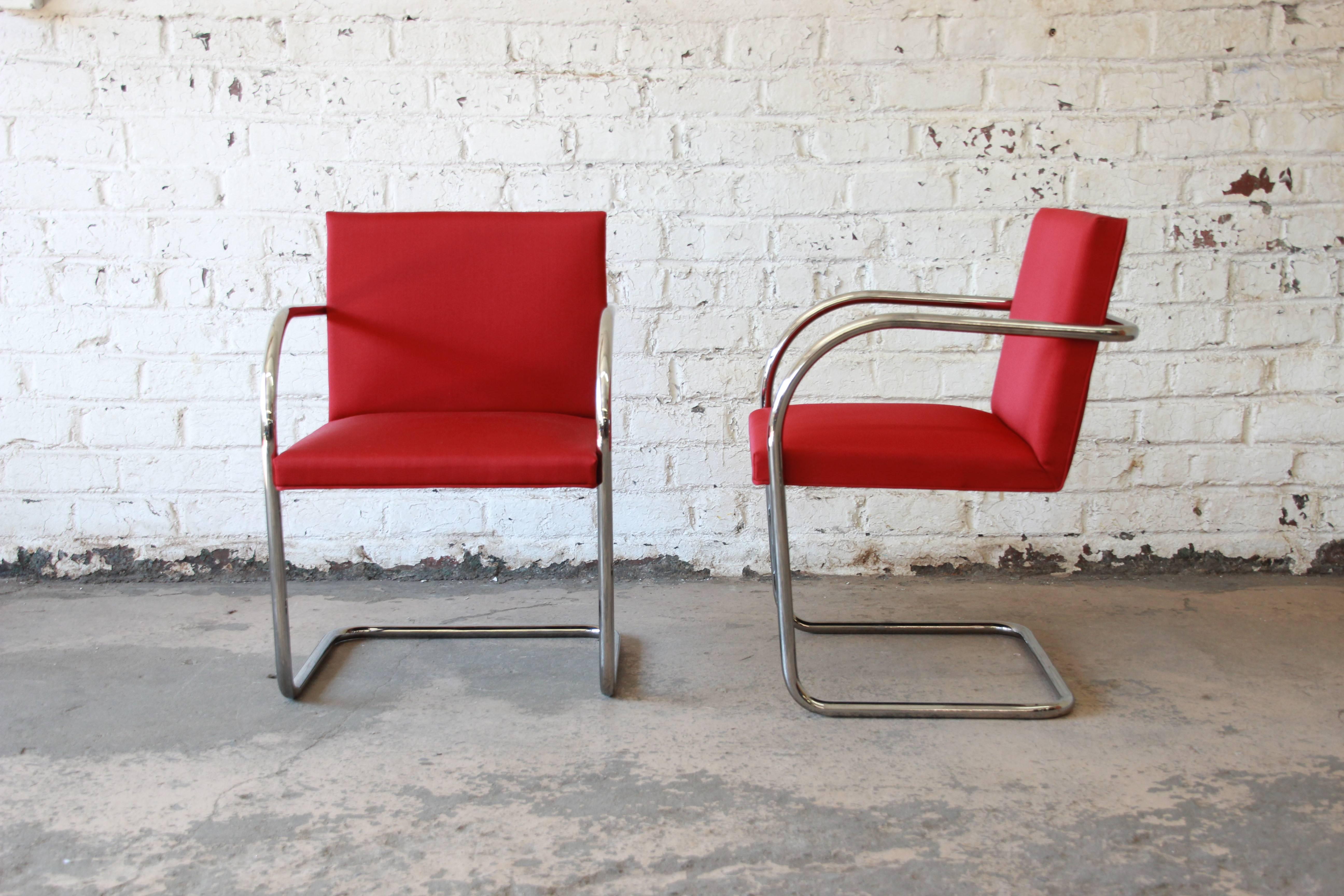 An excellent pair of Brno tubular chairs in crimson red wool upholstery. Designed by Ludwig Mies van der Rohe in 1930 for the Tugendhat House. Chrome-plated steel frame. Signed label Knoll International. Arm height is 25.5