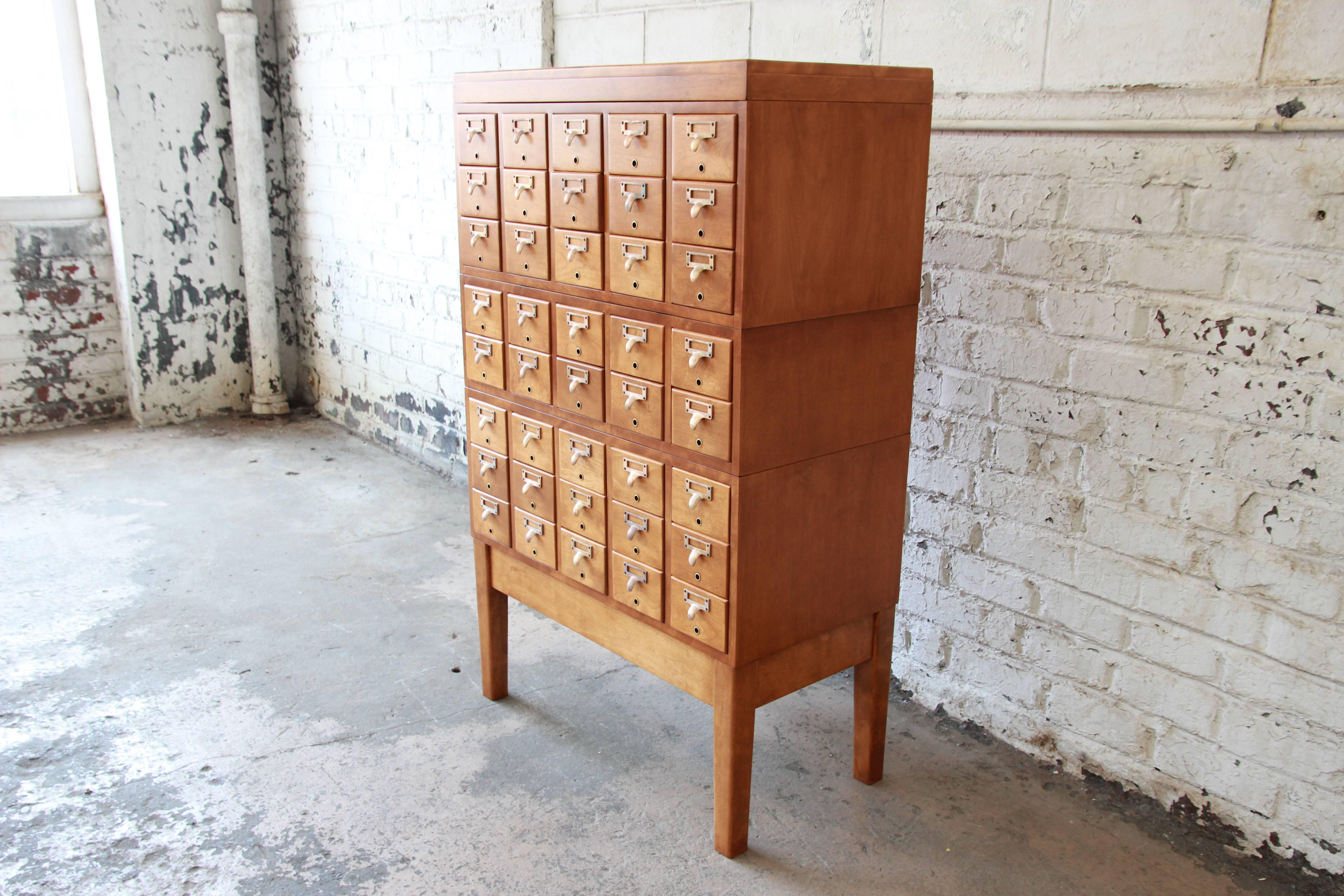 A rare and exceptional Mid-Century 40-drawer library card catalog. The catalog features solid maple construction, with dovetail joints. It comes in five stacking units, including: base, three sections of drawers, and the top. The catalog has been
