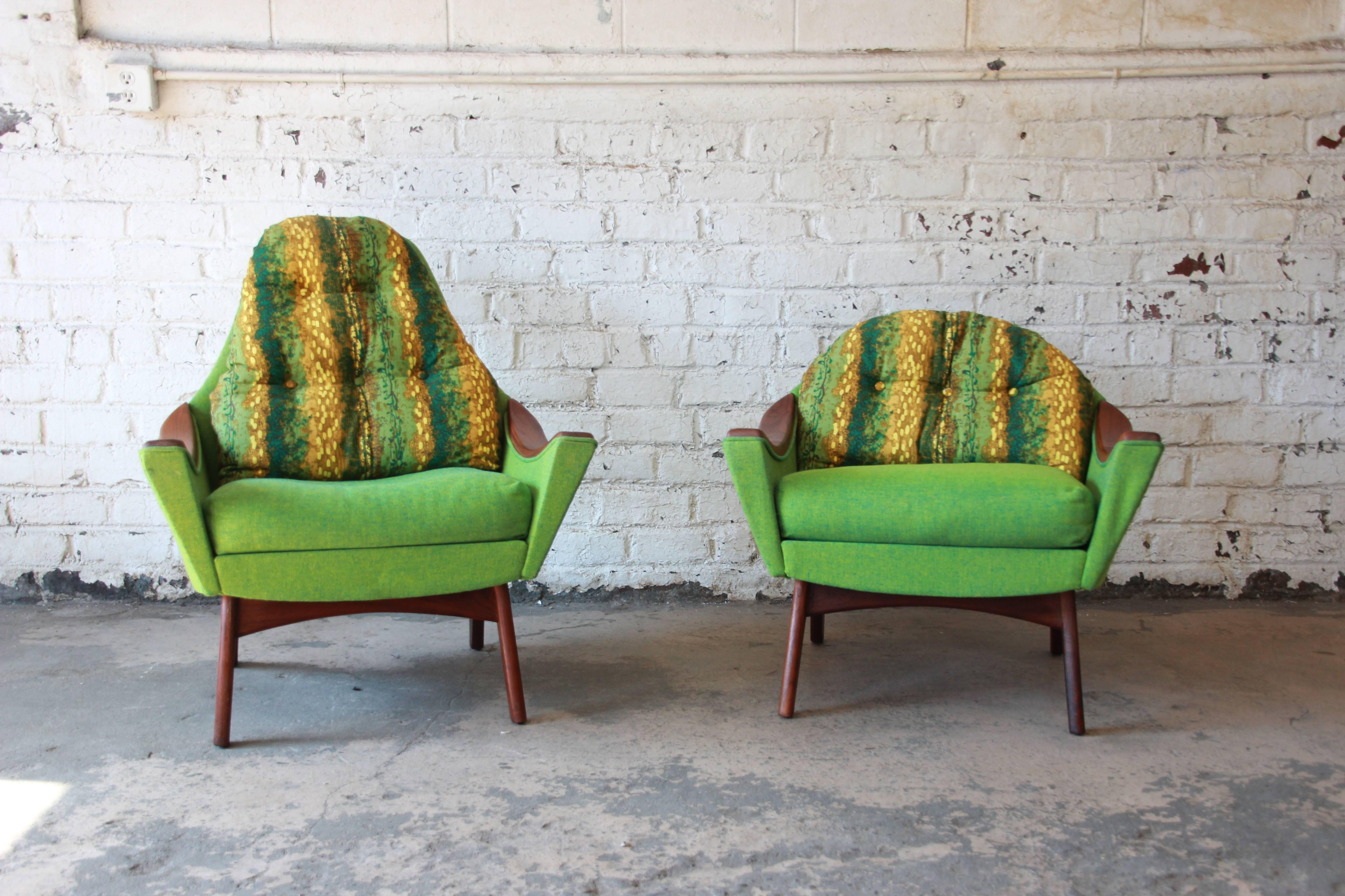 An outstanding pair of his and her Mid-Century Modern lounge chairs designed by Adrian Pearsall for Craft Associates. The chairs feature gorgeous sculpted walnut frames and armrests and all original green and gold upholstery. The upholstery is in