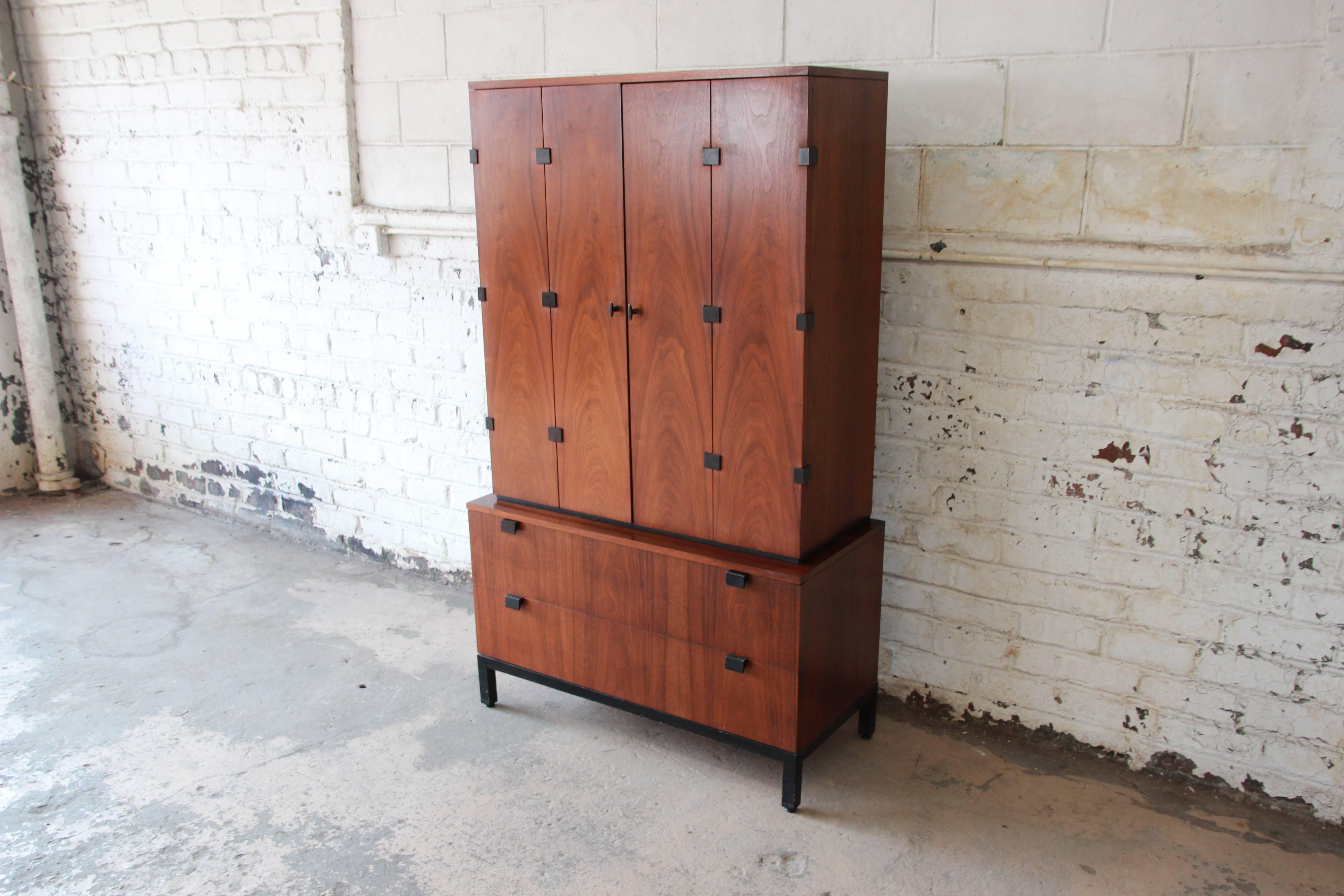 An outstanding Mid-Century Modern walnut gentleman's chest designed by Milo Baughman for Directional. The two-piece cabinet features stunning walnut wood grain and sleek Mid-Century design. It offers ample room for storage. The top piece has