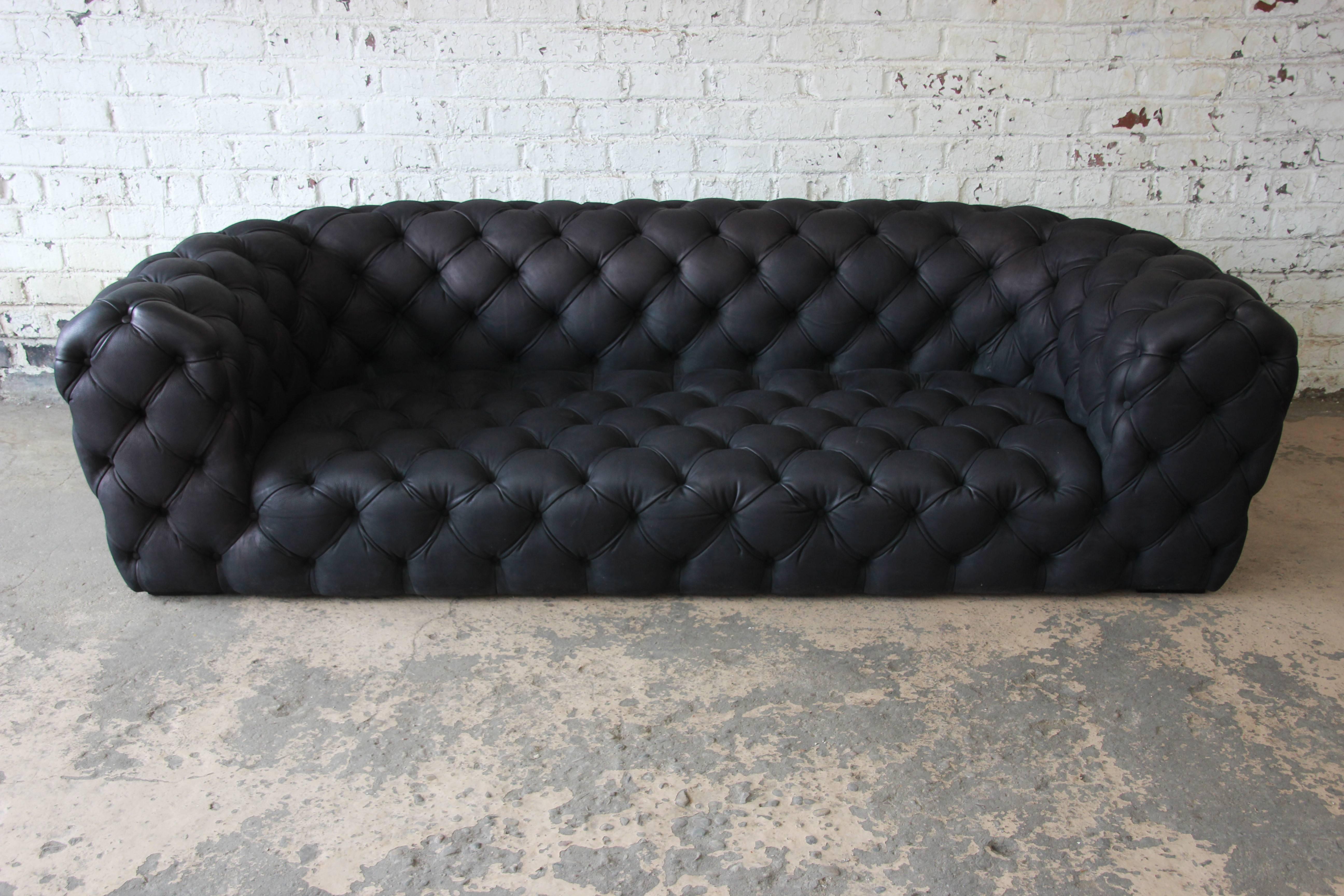 Offering an outstanding Italian tufted black leather Chester Moon sofa designed by Paola Navone for Baxter. The sofa features high grade black leather upholstery, tufted on all sides. The leather is soft and comfortable. A modern take on the English