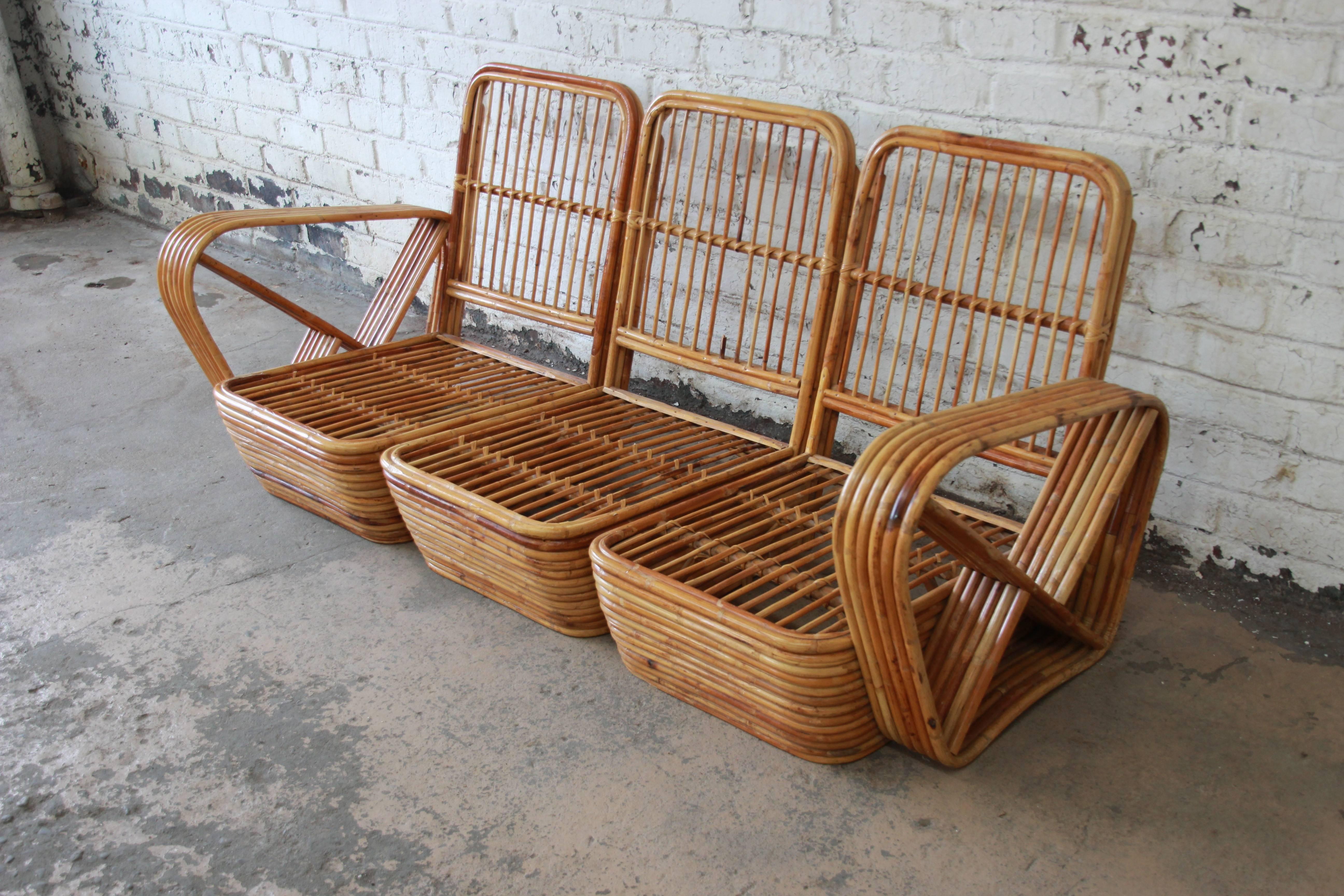 A very nice bamboo Pretzel sofa attributed to Paul Frankl. The sofa features an unmistakable six-strand pretzel design. The rattan is in good condition with normal wear from age and use. The upholstery is clean with a floral landscape design and the