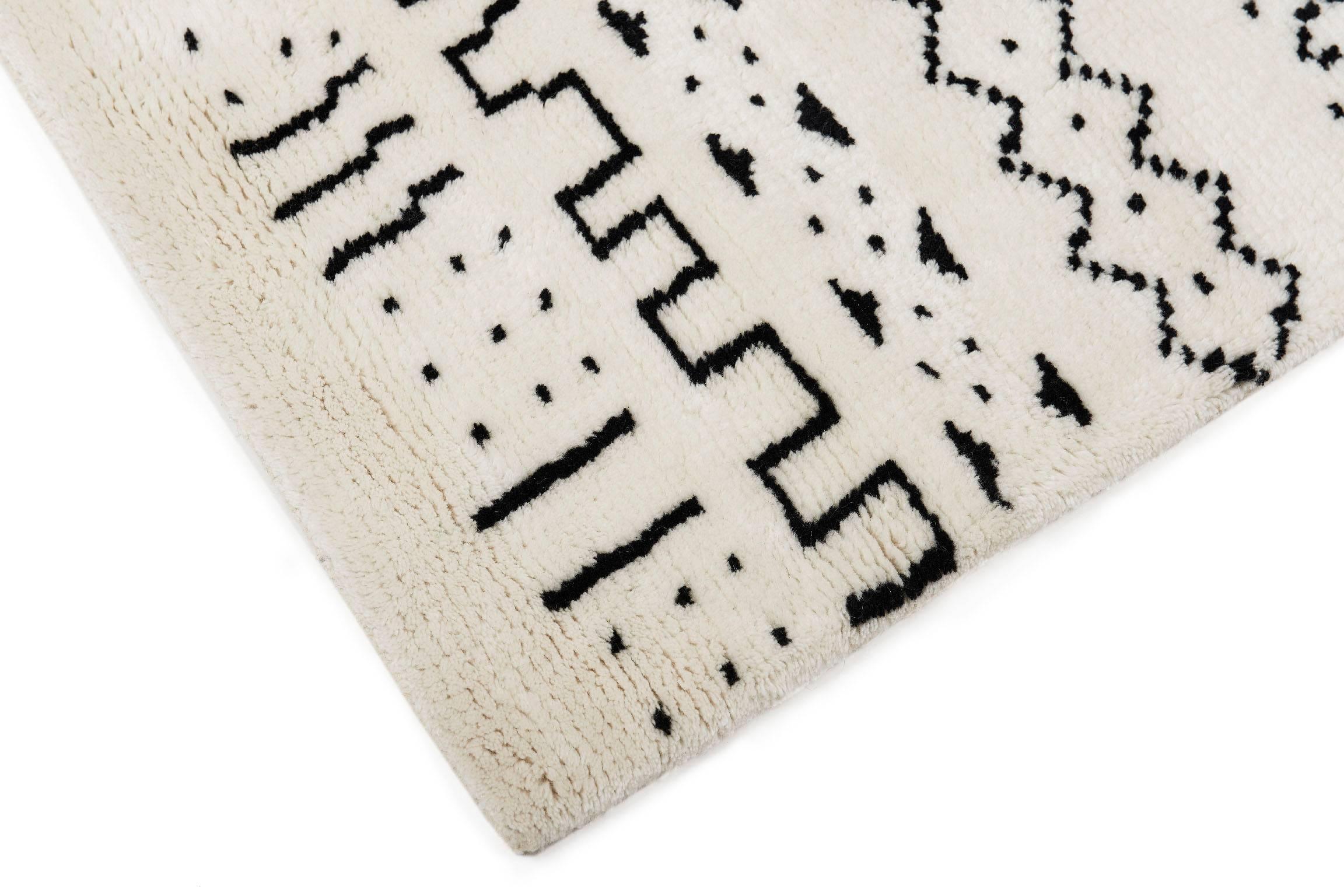 The ultimate rug for lounging, reading, or sleeping. The Bintou black and white rug is hand-knotted with 100% high quality New Zealand wool. Super soft and plush with a Moroccan Inspired design. Designed by Aelfie.