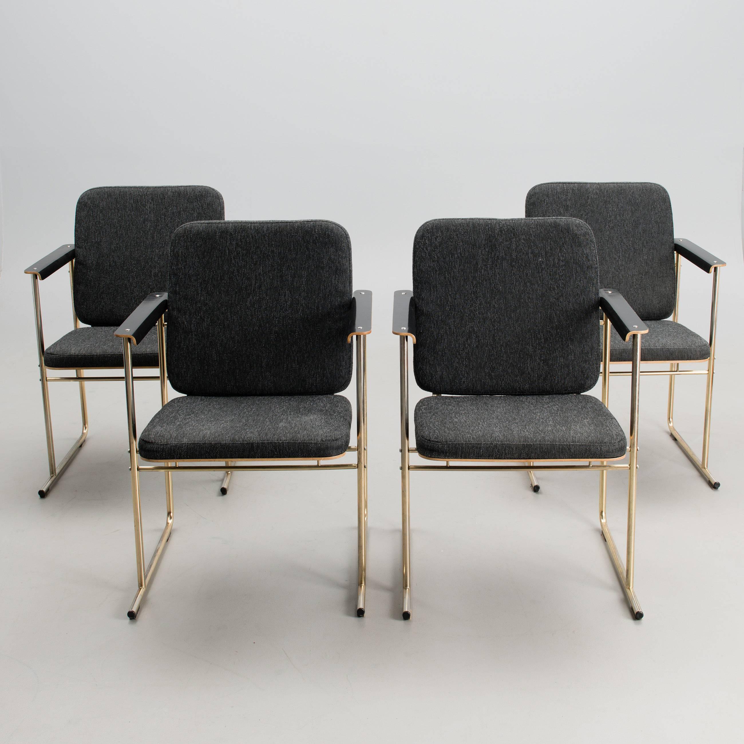 Set of four open armchairs model 'Skaala' designed by Finnish architect Yrjö Kukkapuro for Avarte Finland. Labelled by the manufacturer.

Seat, backrest and armrests of formed birch plywood, edges natural, faced in black laminate. Base of tubular