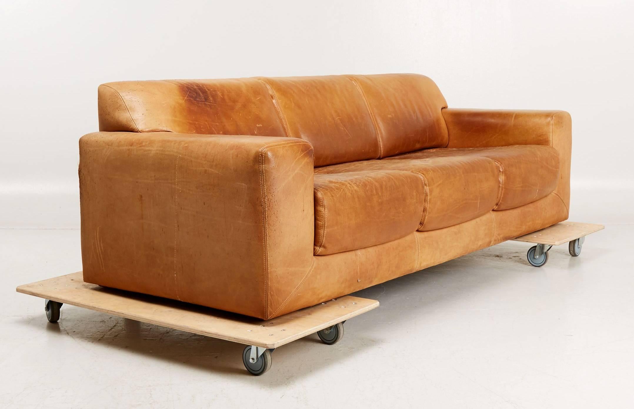 Three-seat sofa upholstered in beautiful vintage oxhide brown leather, produced by DUX in Sweden in 1970s. Scandinavian Modern.