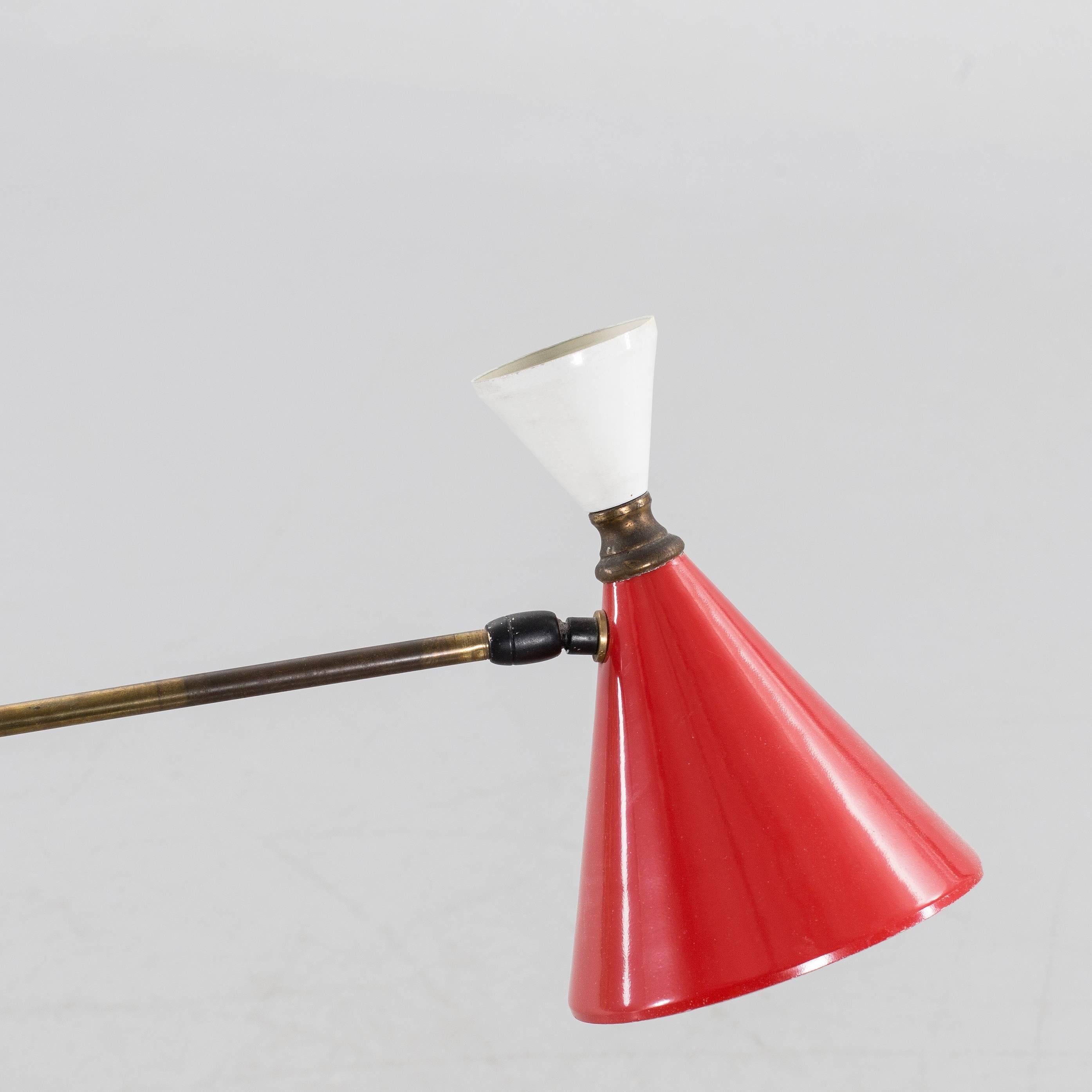 Italian mid-20th Century handmade floor lamp. Base in stone, brass articulated arm, red and white lacquered metal shade.
