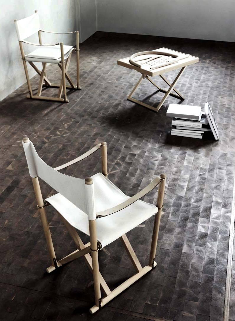 Pair of folding chairs designed by Mogens Koch in 1932 and manufactured by Rud. Rasmussen cabinetmaker in Denmark. Made in natural beech wood and brass. Back, seat and cushions in light canvas. Armrests in full grain leather. Included brass