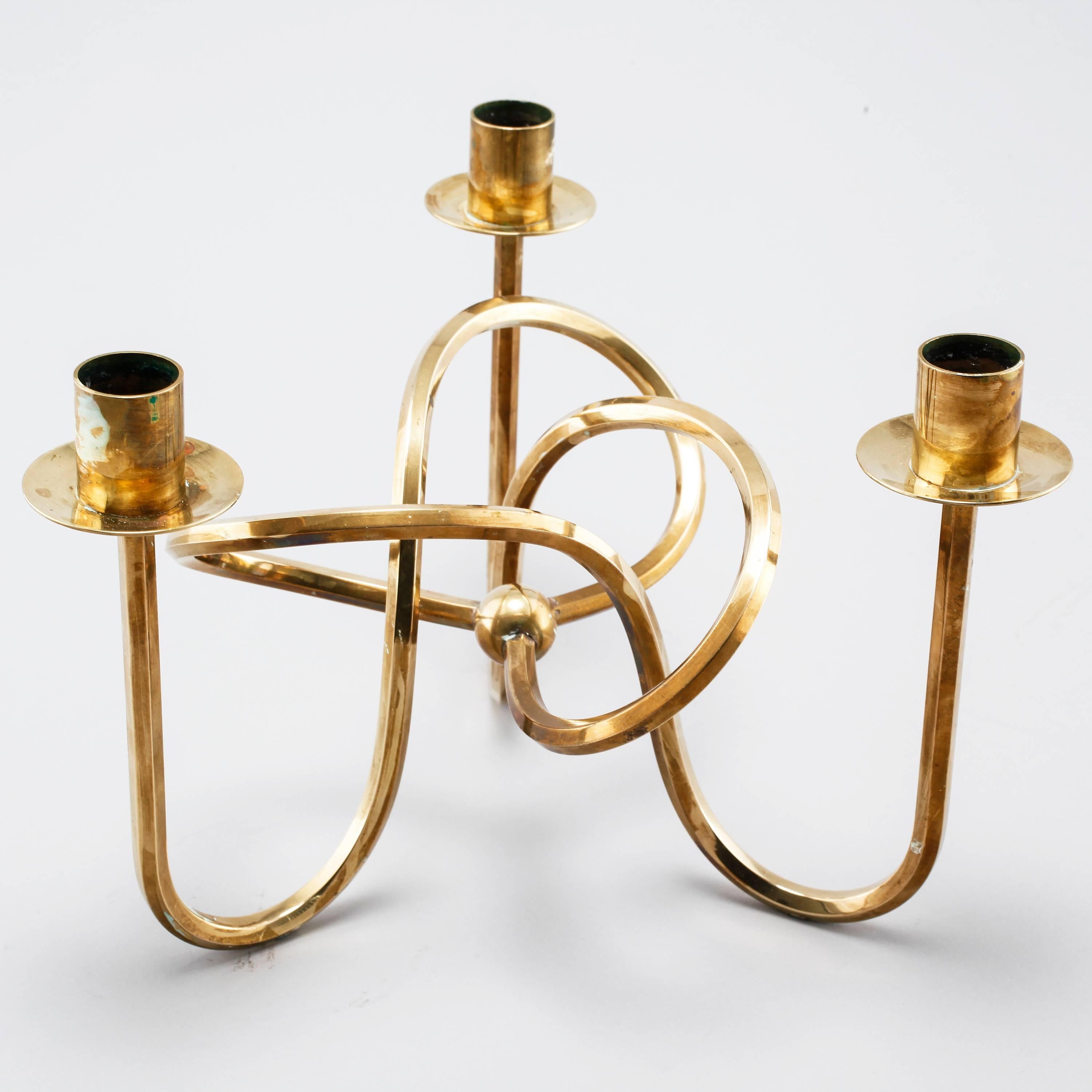 Three holder candlestick made in solid brass designed by Josef Frank and manufactured by Svenskt Tenn in Sweden.