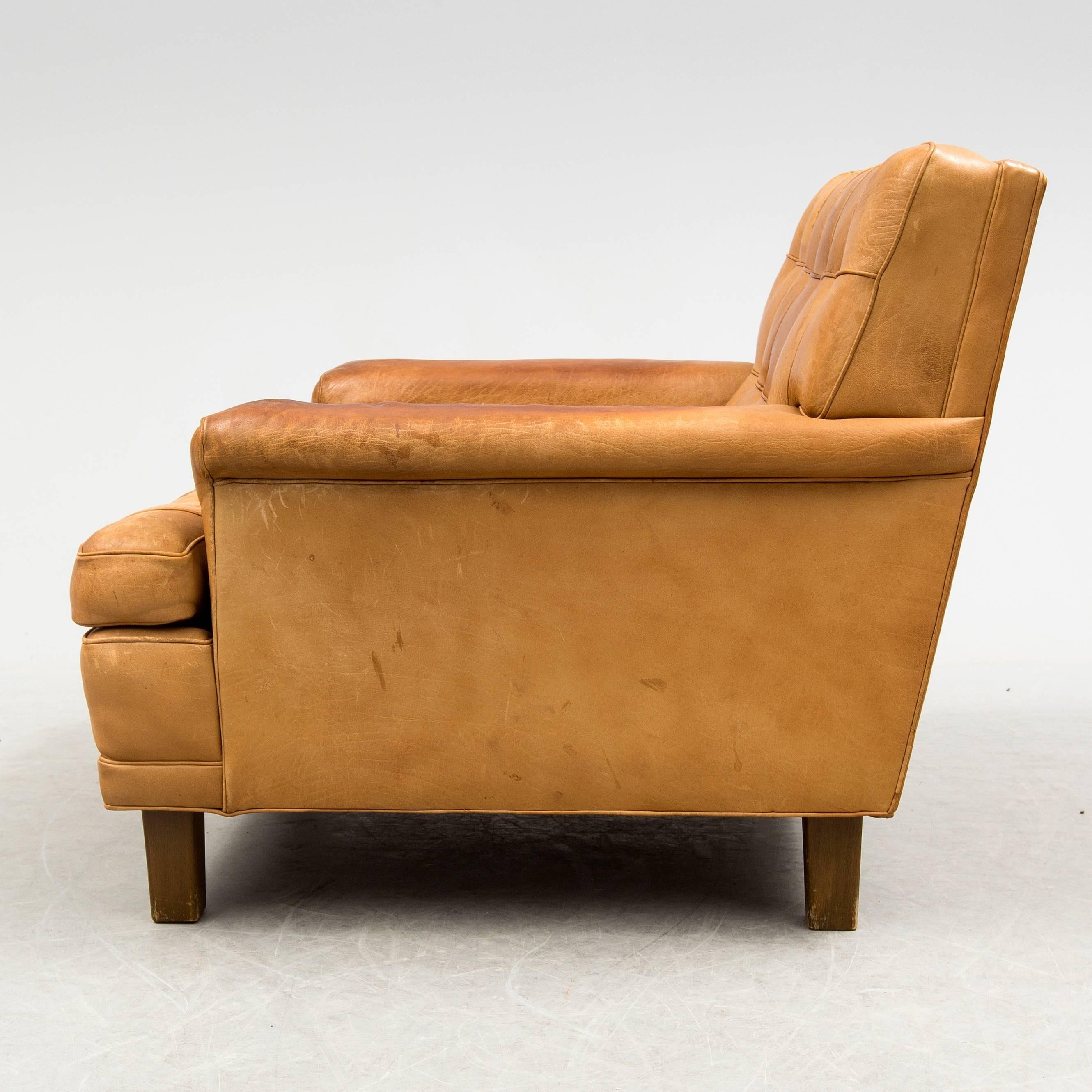 Big armchair model 'Mexico' designed by Arne Norell. Beautiful vintage brown buffalo leather upholstery with buttons. Produced by Arne Norell Möbel AB, Aneby, Sweden in 1970.