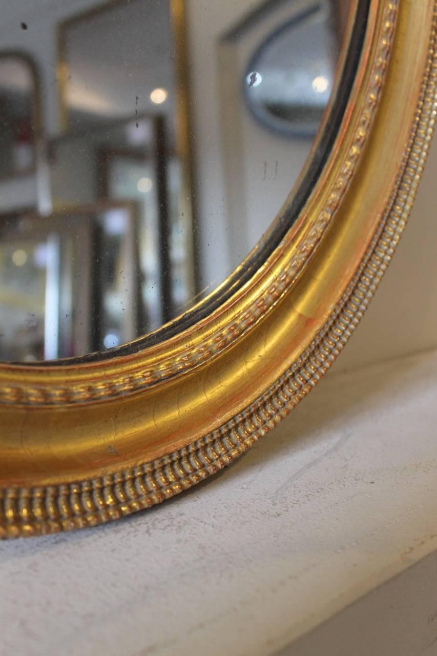 Gilt 19th Century French Ripple Style Oval Mirror with Mercury Plate For Sale