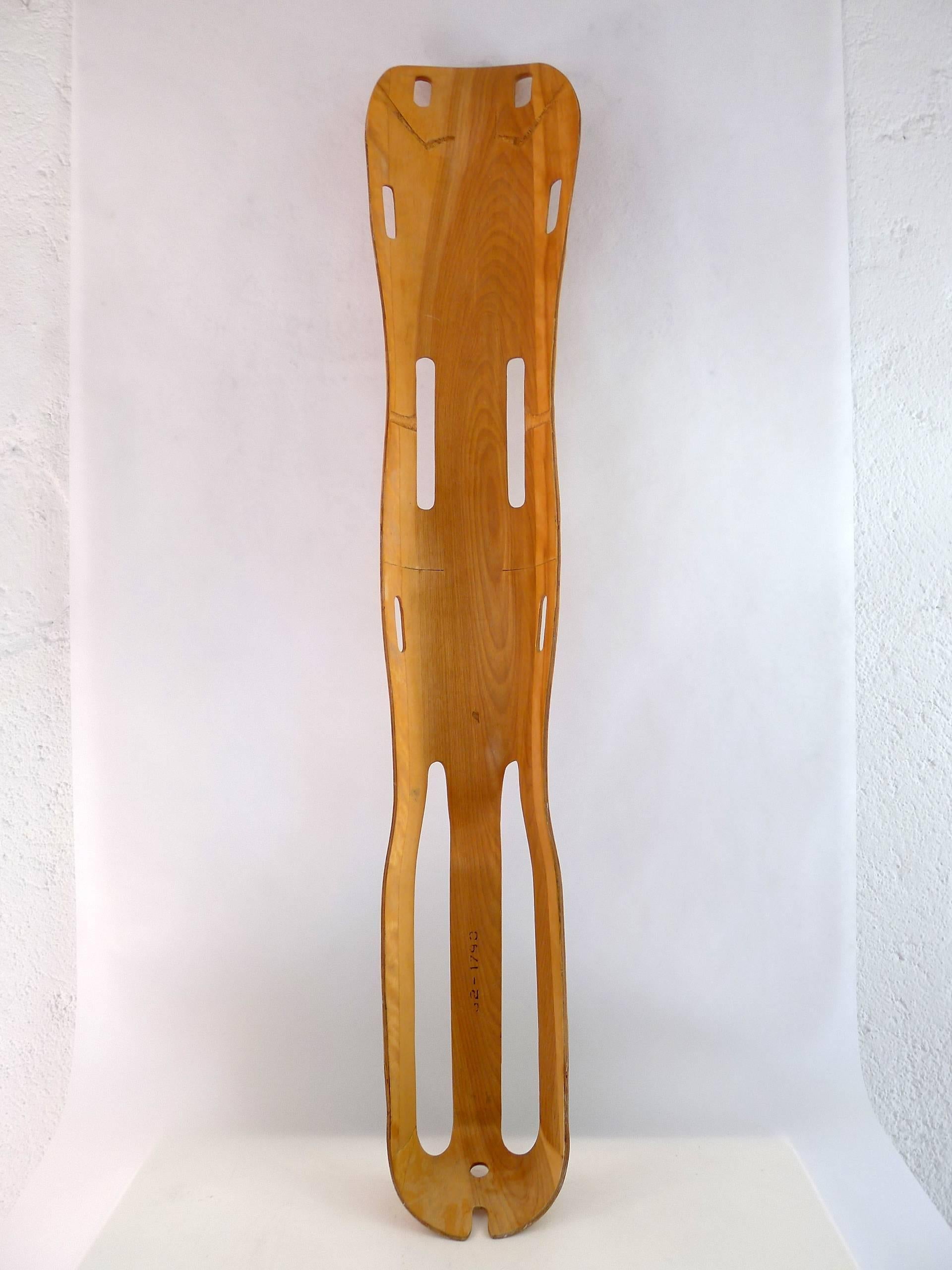 A leg splint designed by Charles and Ray Eames during WW II for the US Navy , produced by Evans Products

Not only a leg splint but a sculptural piece from the innovative process of bending and molding plywood, precursory to the post-war furniture