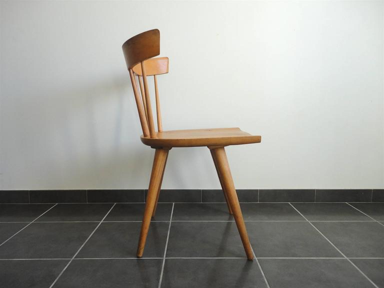 Maple spindle back dining chair from the Planner Group series designed by Paul McCobb and manufactured by Winchendon, Massachusetts. Very good condition with a fantastic patina.