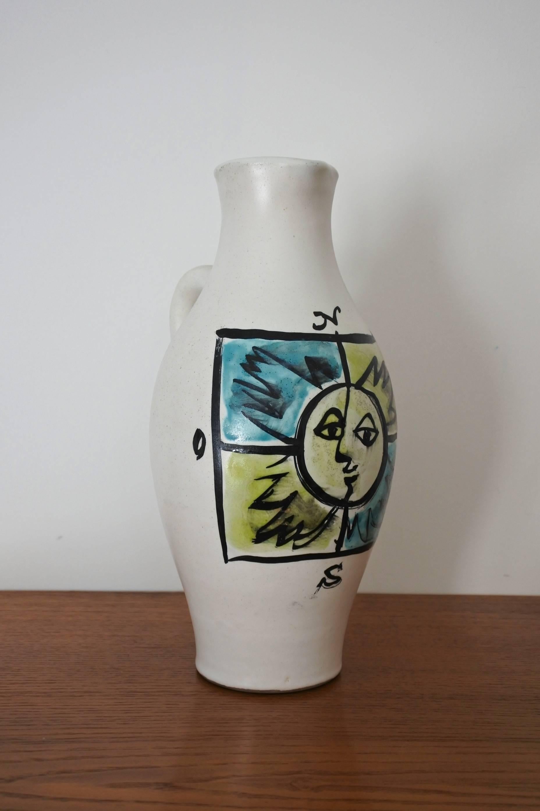 Pitcher vase by renowned french pottery artist Georges Jouve.
Glazed earthenware. Hand painted decor on the vase showing the 4 cardinal points with a sun in the middle.
Signed with the artist's cypher. 
Circa 1955
Decor documented in the book