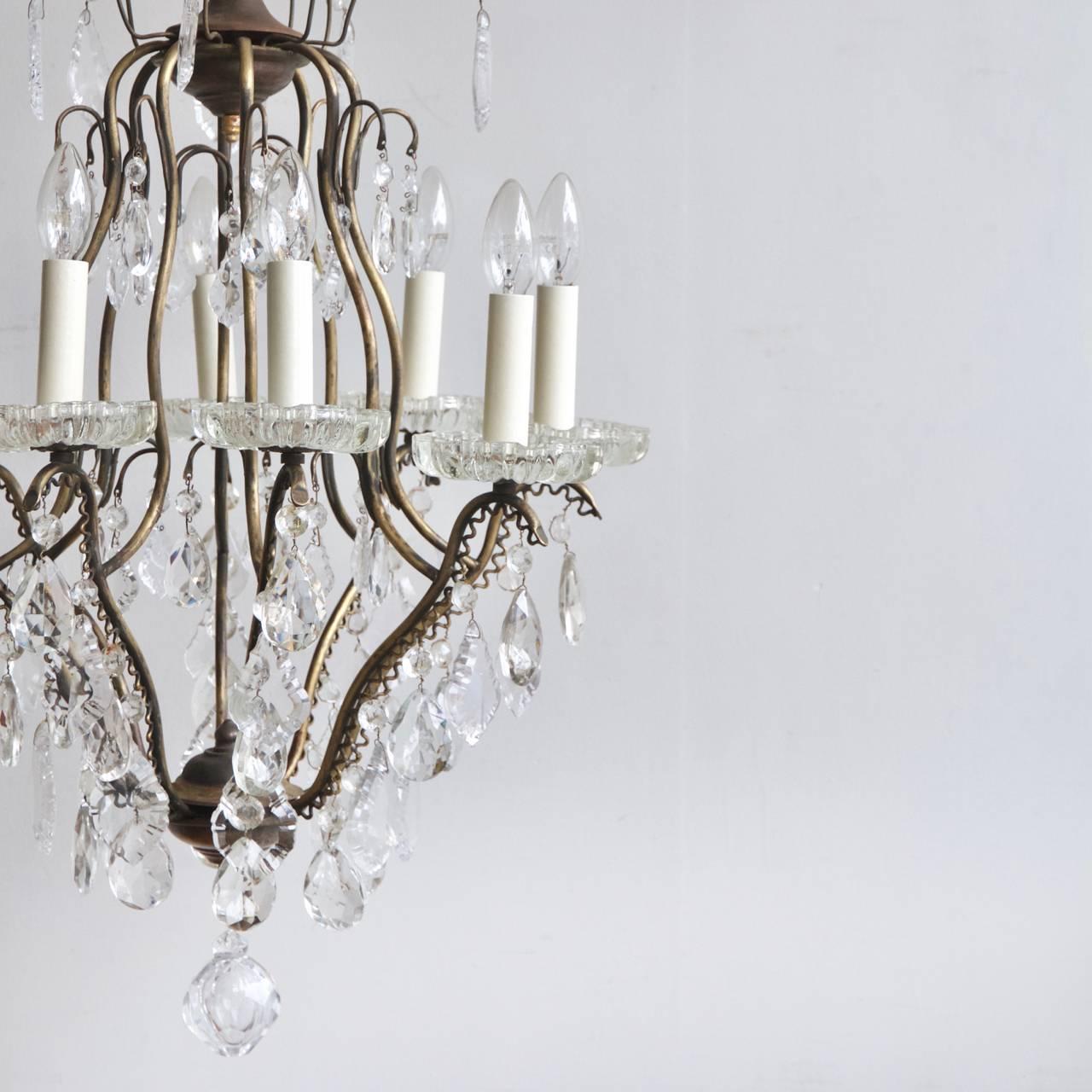 Early 1900s large birdcage chandelier with crystal bobeche pans and a mixture of antique crystal pear drops and glass flat leaf drops. Chandelier uses eight SES Lamps, E14. Supplied with chain and ceiling rose.