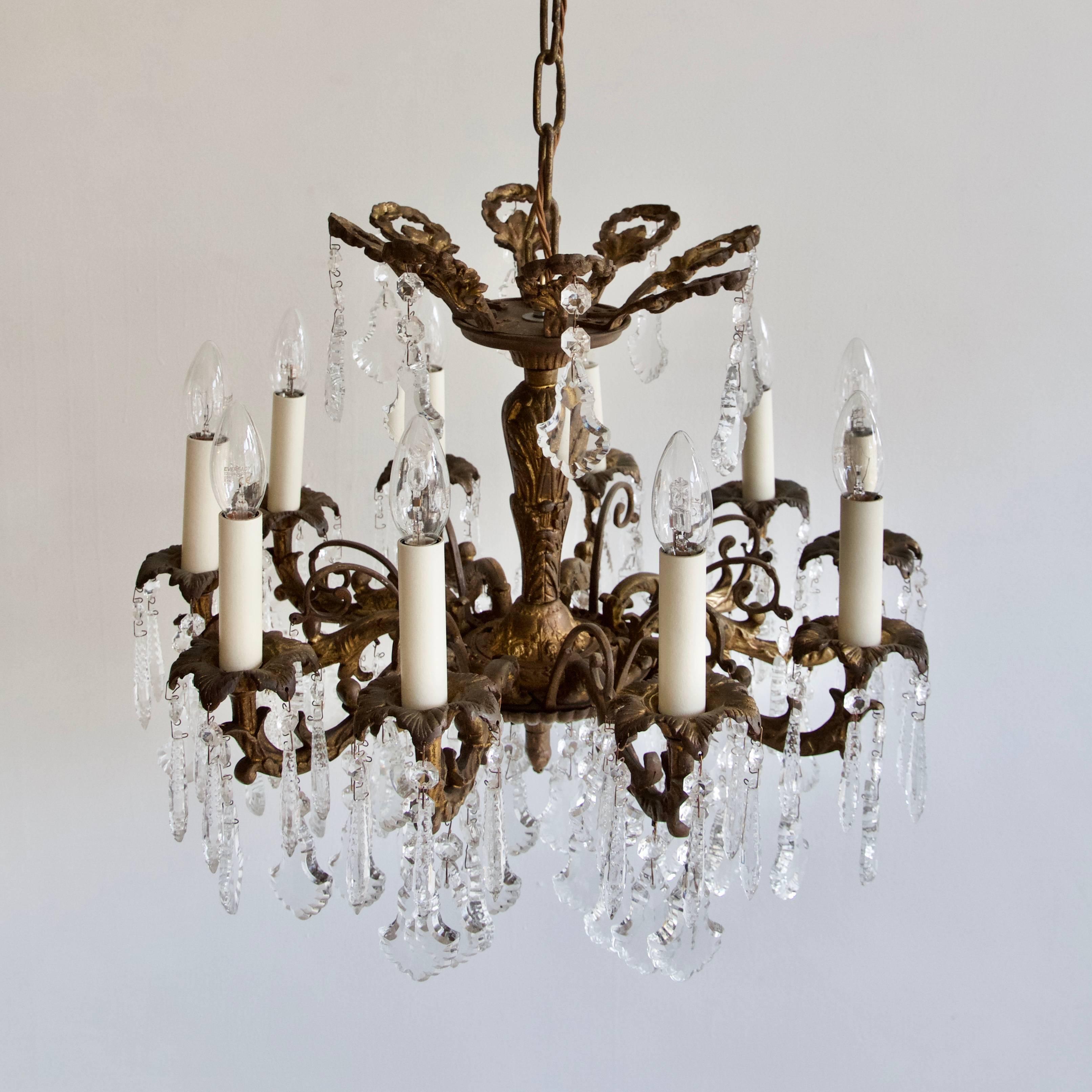 Gilt chandelier with moulded faceted glass icicles and flat leaf drops. This chandelier has eight SES, E14 lamps. Supplied with chain and ceiling rose.