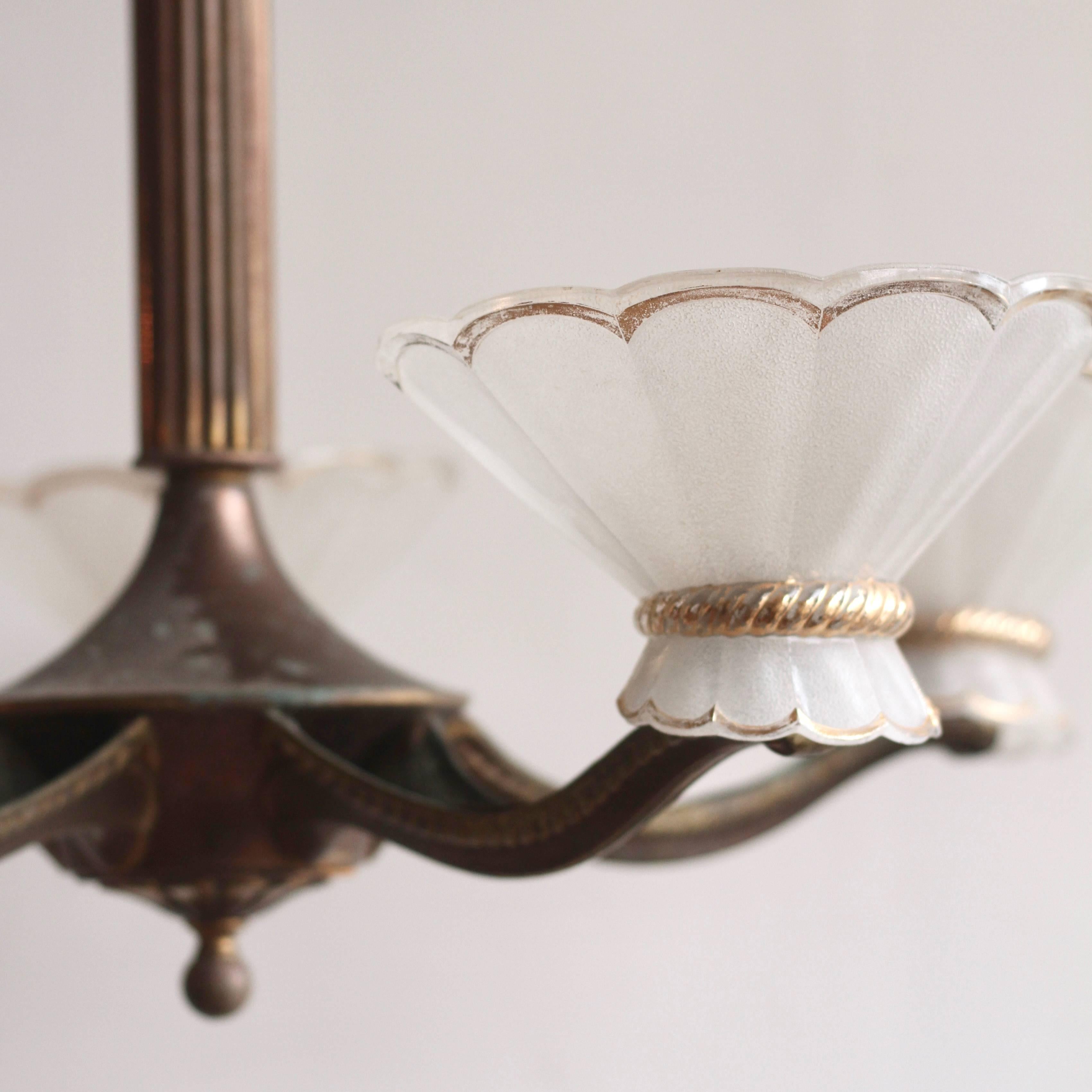 French 1940s five branch brass chandelier with moulded art glass shades. Pendant uses Bayonet Cap fittings, B22.