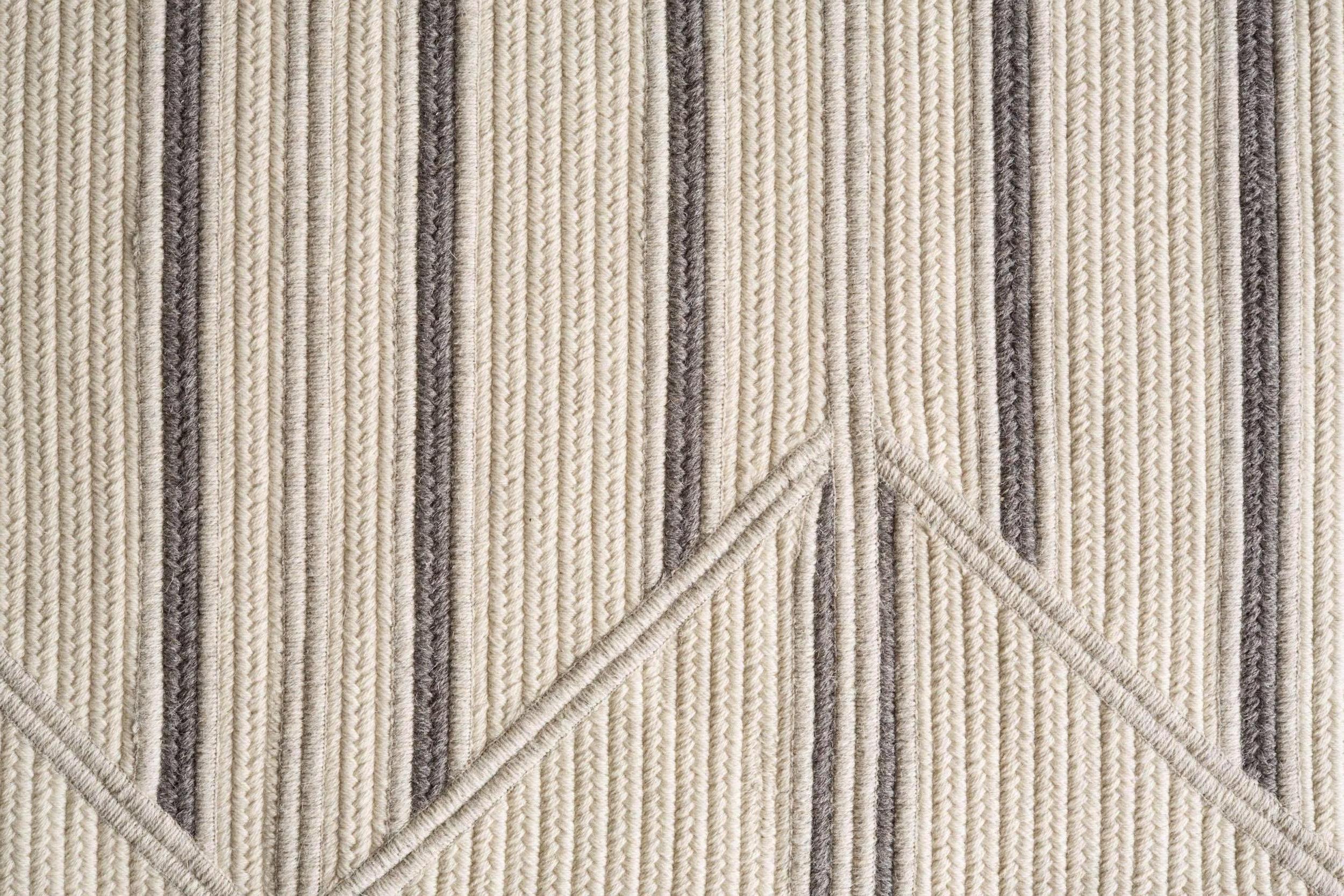 Inlay Grey and Cream Natural Un-Dyed Wool Geometric Stripe 8'x10' Rectangle Rug. A finishing technique within the rug creates shifts in line and texture. Pieces are cut and sewn in cream, light grey and dark grey tones of natural un-dyed