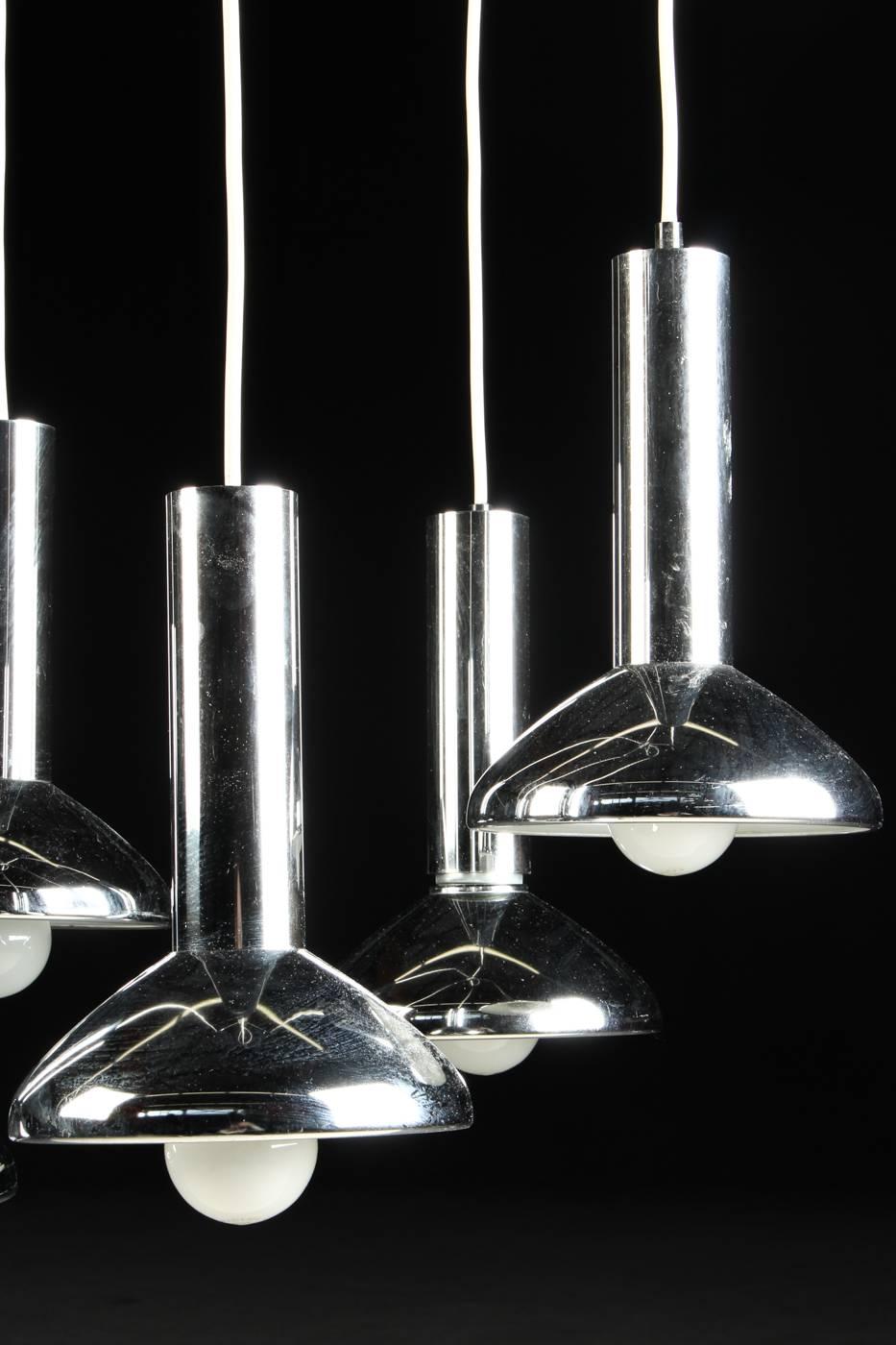 This modern pendant light was produced by Hustadt-Leuchten in Germany. It features five chrome-plated lamp shades, each with a diameter of Ø 17 cm and 26 cm length.