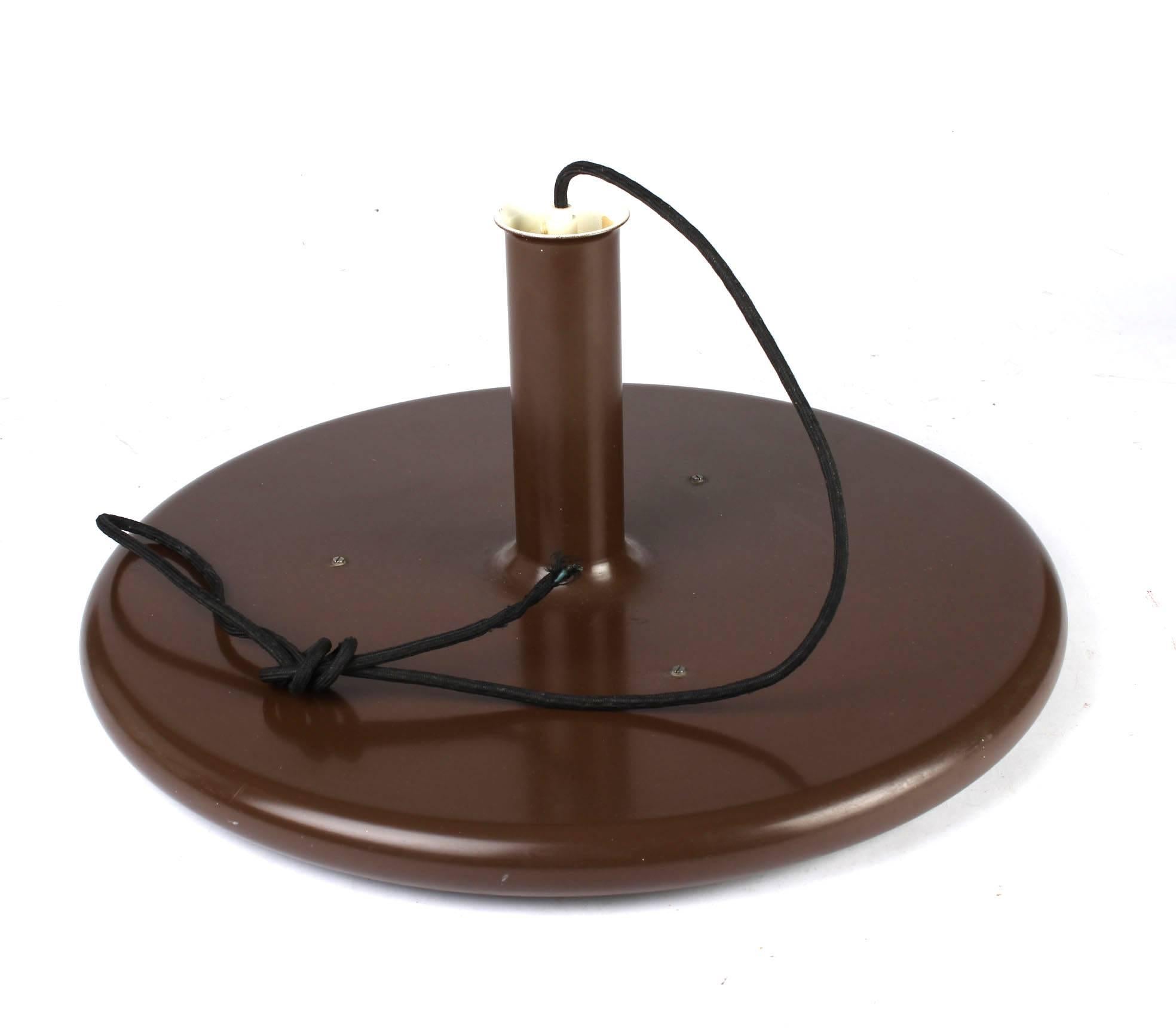 This is a large UFO lamp by Hans Due for Fog & Mørup. It features a simple round plate-shaped pendant in a dark brown color. The pendant has a size of 50cm diameter and 24 cm in height. The total height is adjustable.
