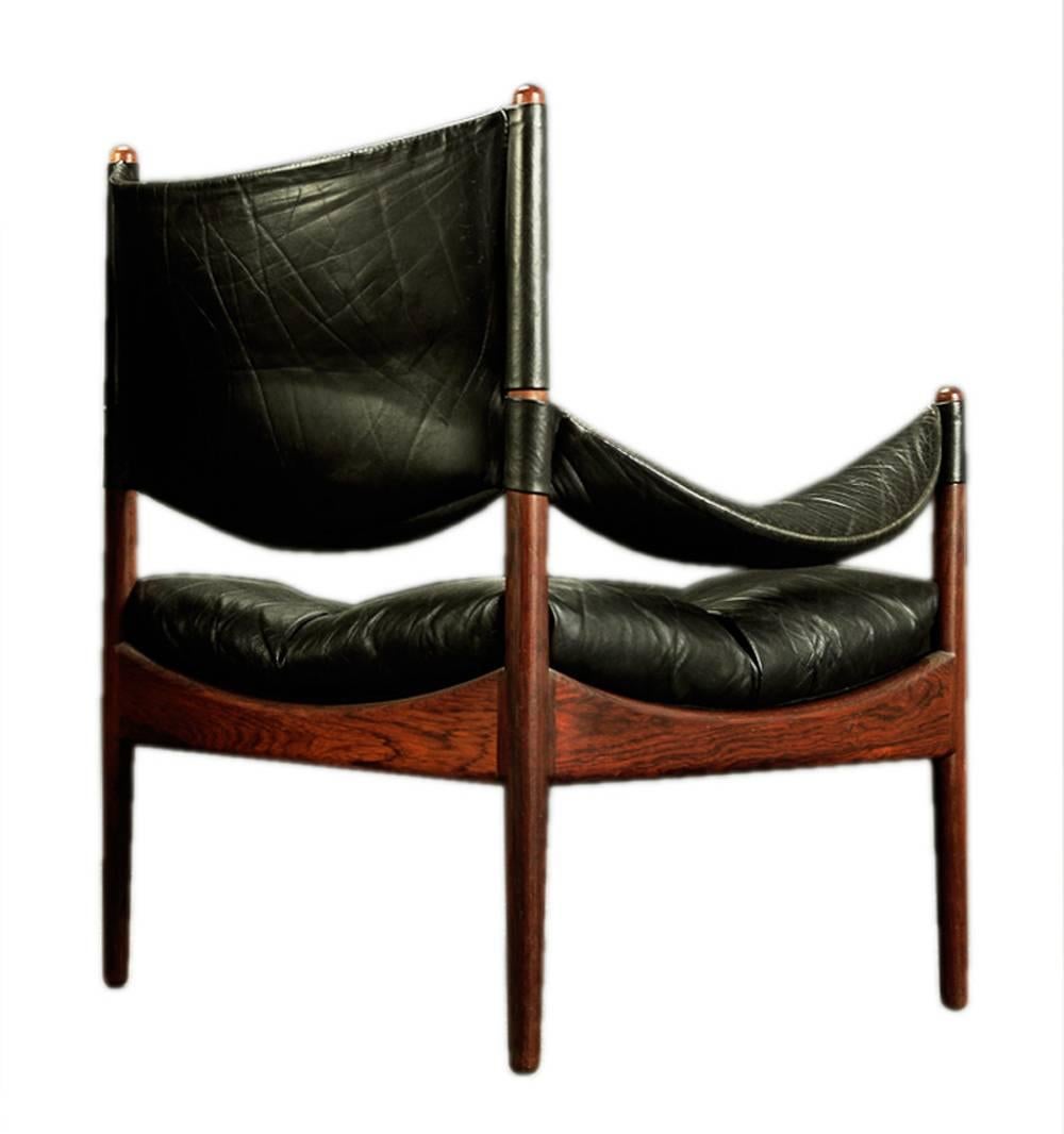 This pair of patinated leather lounge chair features a solid rosewood frame. It is a Mid-Century design Classic by Danish designer Kristian Vedel, Model Modus, manufactured in the 1960s by Søren Willadsen Møbelfabrik.