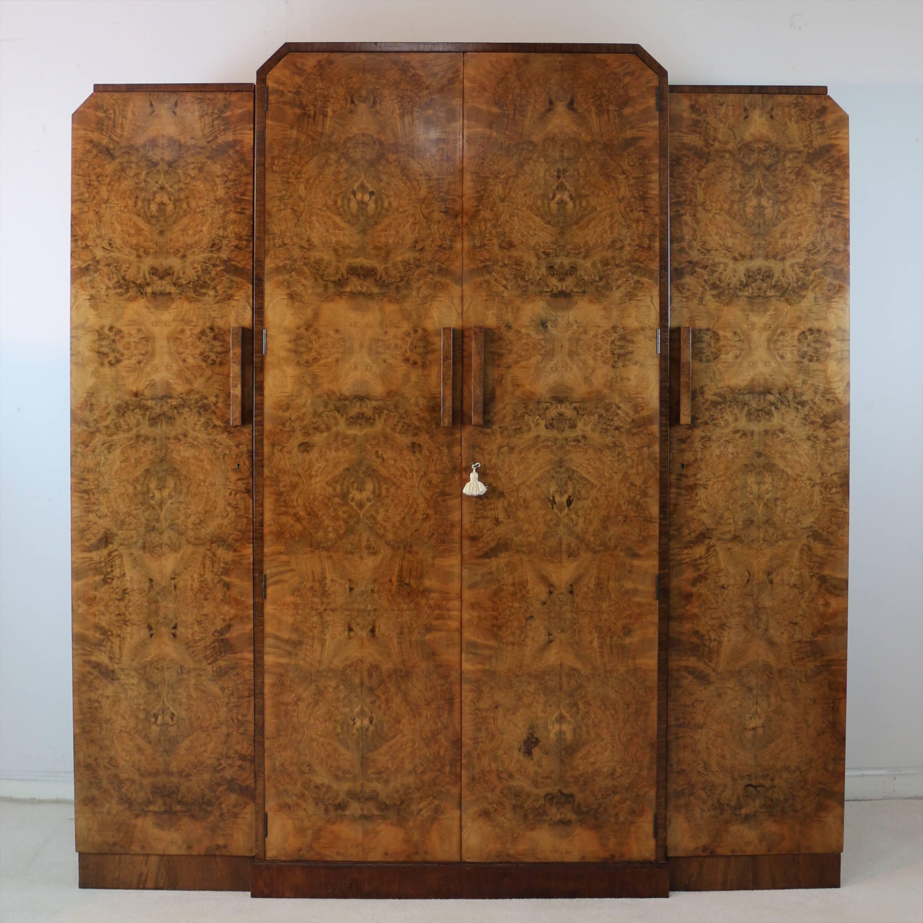 An English Art Deco four-piece burr walnut and rosewood crossbanded bedroom suite attributed to H & L Epstein and dating to circa 1925. Typically stylish and of superb quality it comprises:

A four-door fitted wardrobe with a rare additional