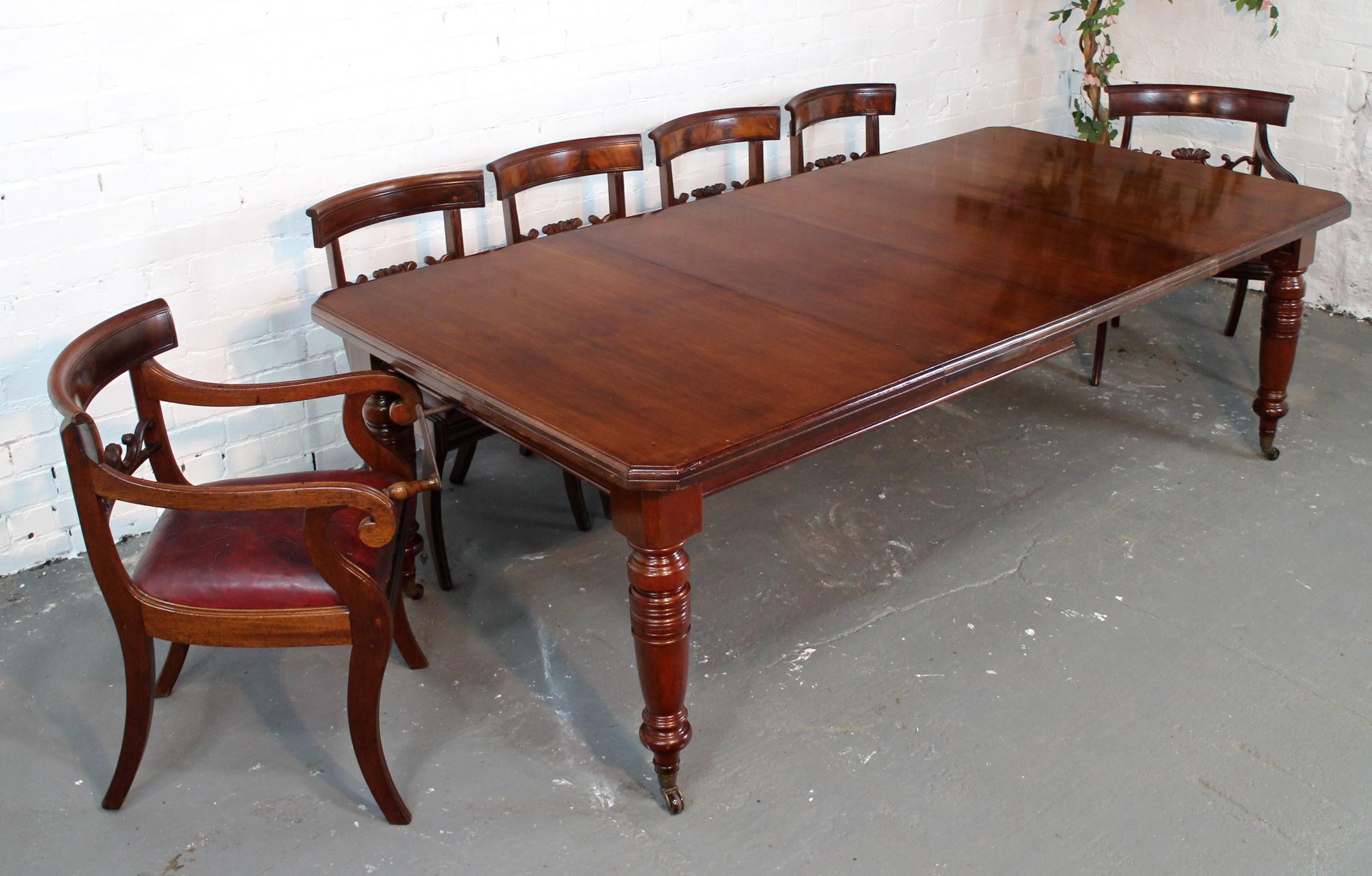 A lovely Victorian extending dining table in mahogany and with two additional leaves. It has a rectangular top with moulded edge and canted corners and stands on four ring turned legs with brass caps and brown pottery castors. The table smoothly