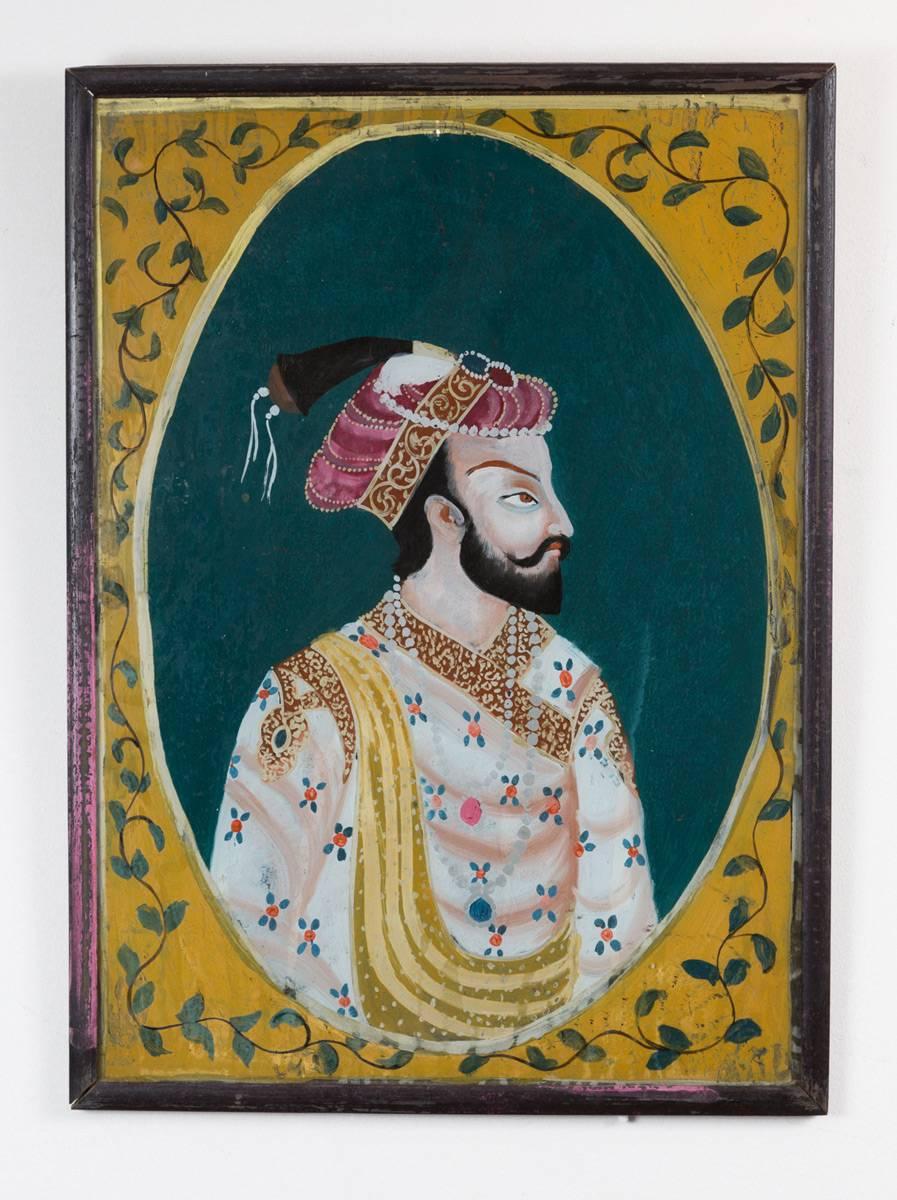 Pair of colorful Indian reverse glass paintings of a Maharaja and his bejeweled wife, in original frames. Label on reverse: S. Husain, photo frame maker, B-56 Makani Mansion—Near Cafe Paris Hotel.


 