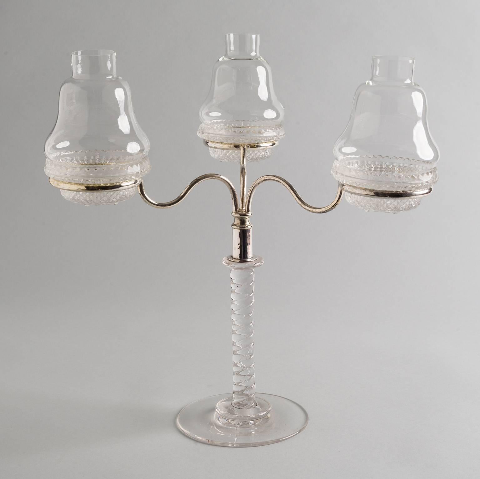 Antique Victorian molded glass and silver plate Cricklite three-arm candelabra. The three molded cups and blown glass shades sit in silver plate rings supported by a spiral glass stem on a circular base. There are seven pieces. Cricklites were