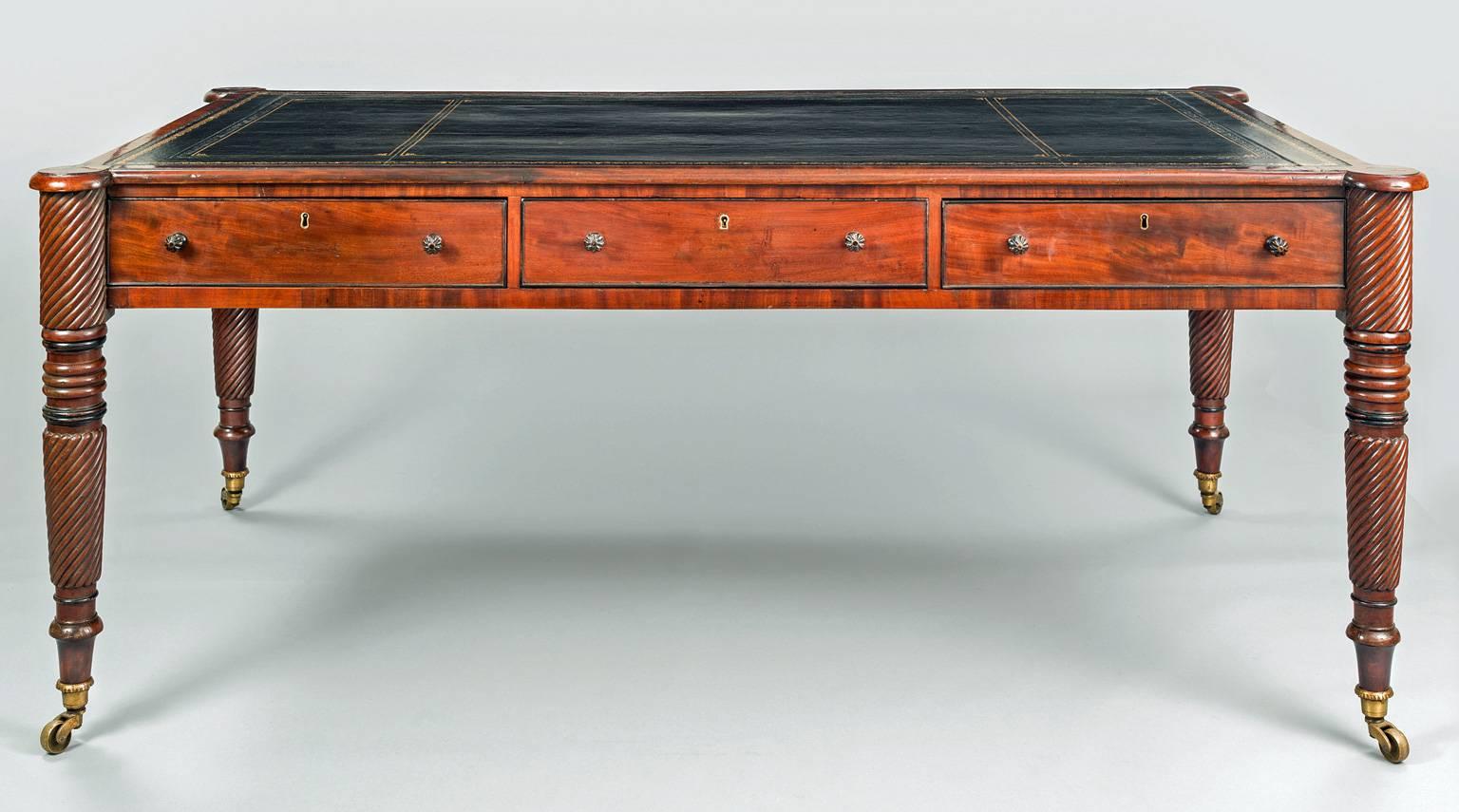 Antique large Regency mahogany partners writing table, the top with unusual projecting cookie-cutter corners and black gilt-tooled leather insert above three drawers on each side with melon-shaped knobs, spiral and ebonized ring turned legs ending