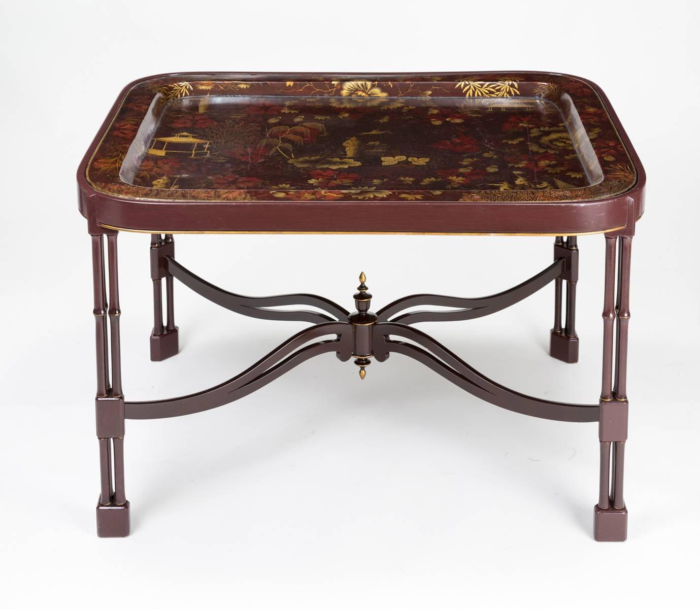 Antique Victorian Papier Mâché rectangular shaped lacquered and gilded tray decorated with Chinese figures, pagodas and floral stencils on a maroon background set into a custom-made maroon stand in Chinese Chippendale style with cluster faux bamboo