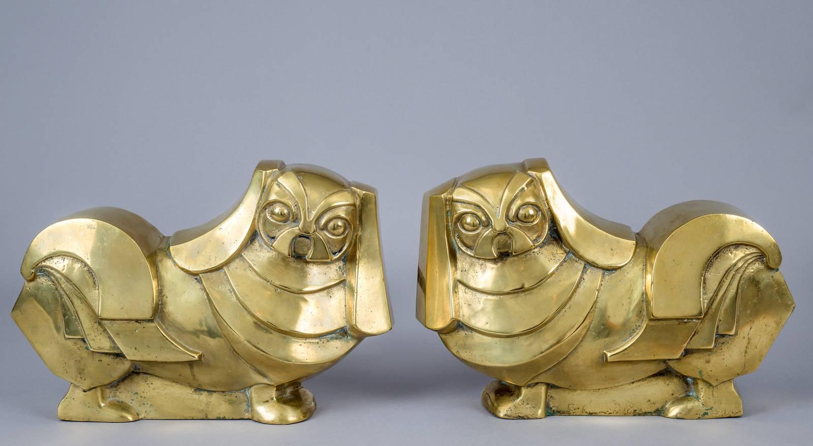 Charming pair of Art Deco brass and wrought iron andirons in the form of Pekinese dogs with brass log stops.
