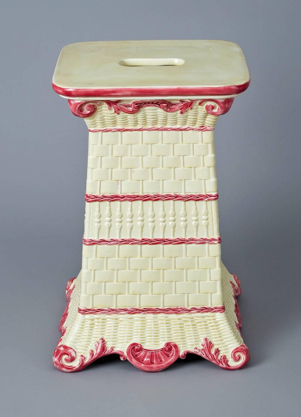 Antique Wedgwood garden seat decorated with four different basket weave designs each separated by dark pink chains, the top with open handle, the top edge outlined in pink, the top and shaped base of shells also decorated in dark pink. The inside