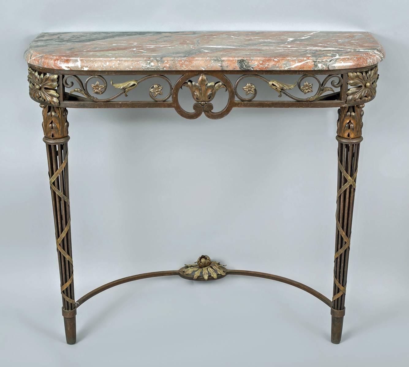 French wrought iron console table with breche marble D-shaped top above an open frieze with S- and C-shaped scrolls and acanthus leaves, the cluster open column legs wrapped with ribbon.  Legs joined at bottom with a concave shaped stretcher