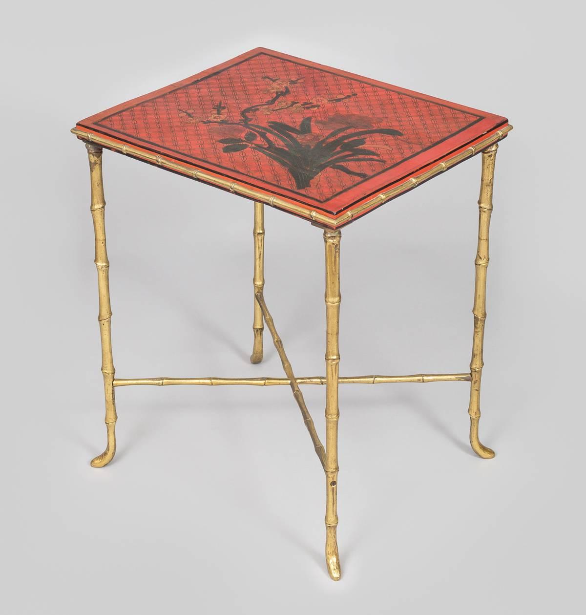 Harlequin pair of red lacquered side tables composed of parts from a panel of a Chinese screen, set into gilded metal faux bamboo frames with X-shaped stretchers and legs.  Each panel is of a different design.  Can also be used as individual coffee