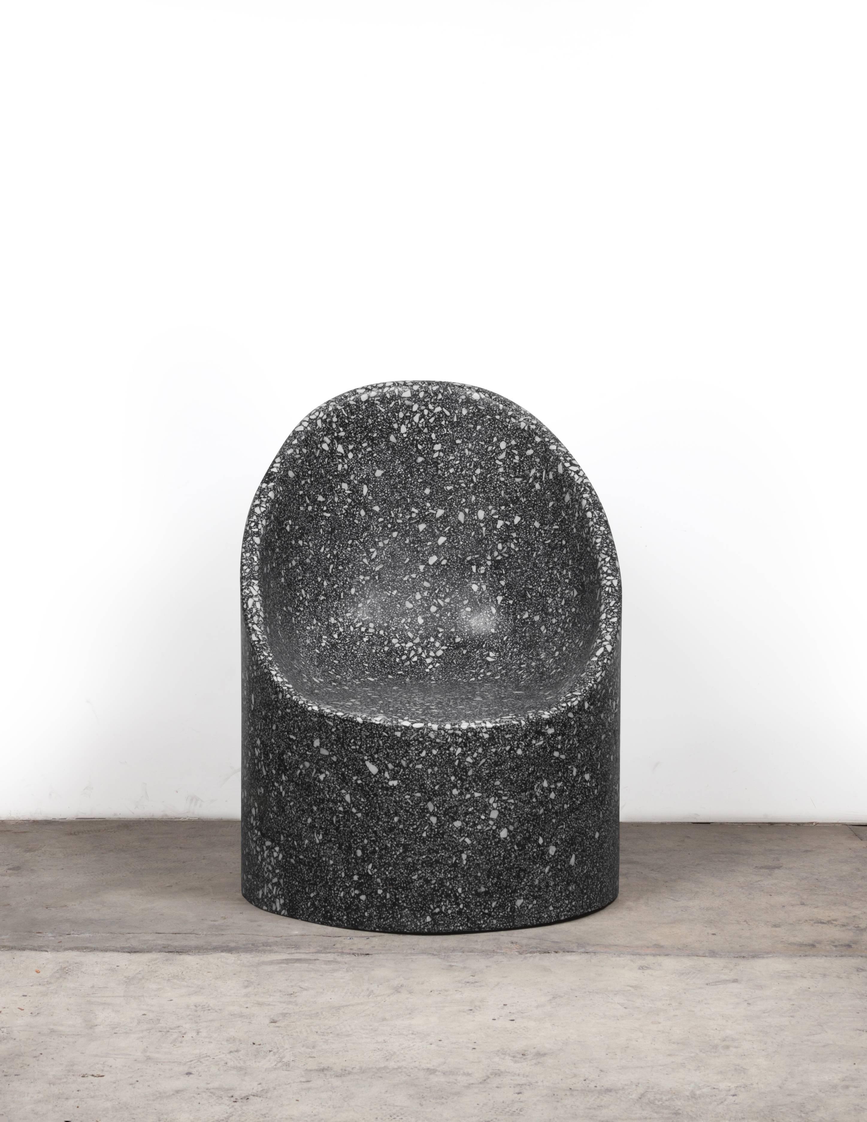 This monumental Cozy Cave chair is shown in black cement with white marble terrazzo. 

Available with and without sheepskin pillows.