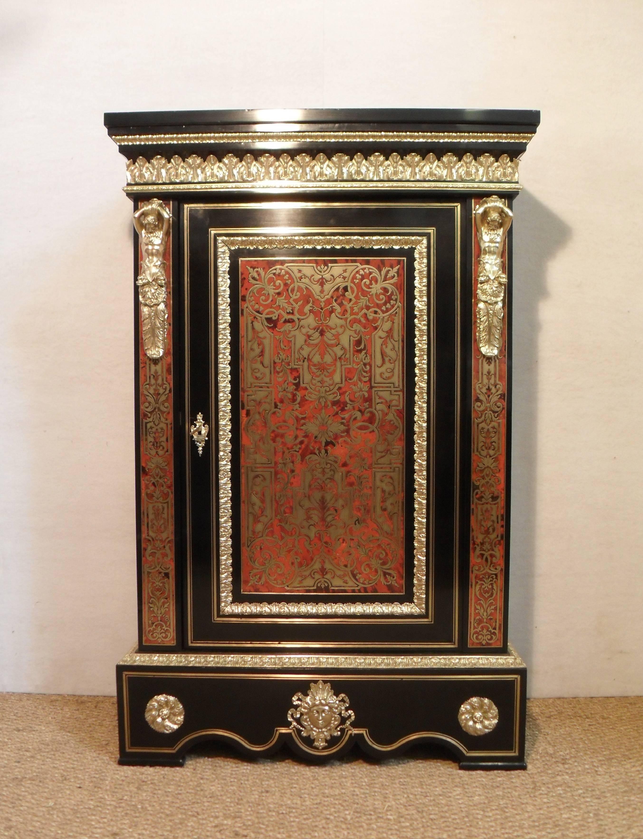 A truly exceptional pair of French ebonised Napoleon III boulle side cabinets inlaid with brass and tortoise shell. The cabinets have a double brass string inlay to the side and fronts and exceptionally good quality gilt bronze acanthus leaf
