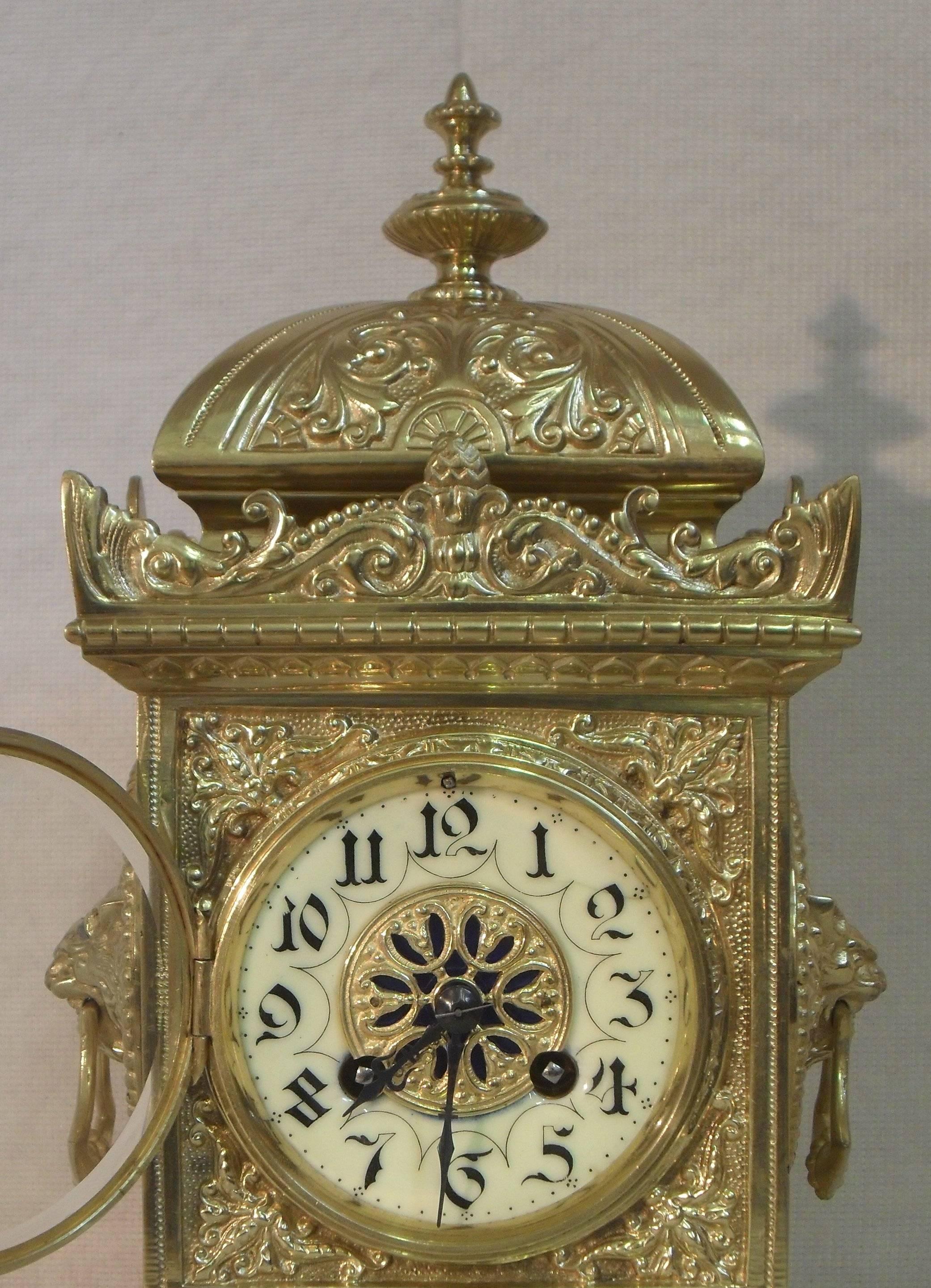 A very decorative French brass gilt mantel clock with side carrying handles The clock has a porcelain chapter ring with a pierced gilt centre and an eight day French movement which strikes the hours and half hours on a gong.
 
The clock is stamped