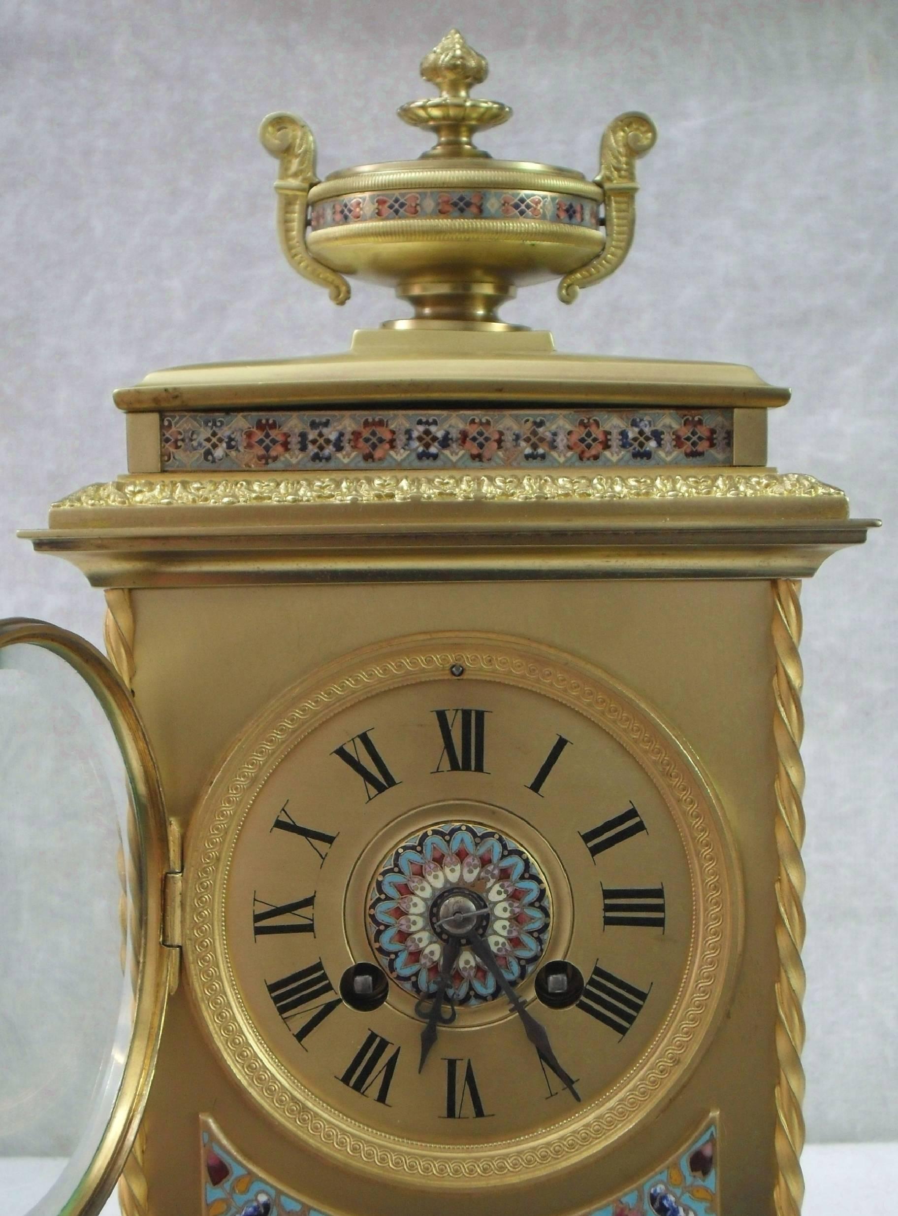 A very good quality and decorative French Belle Epoque brass and champleve mantel clock with colourful inlaid enamels and ornamental brass detail with urn to the top. The movement is a French eight day which strikes the hours and half hours on a