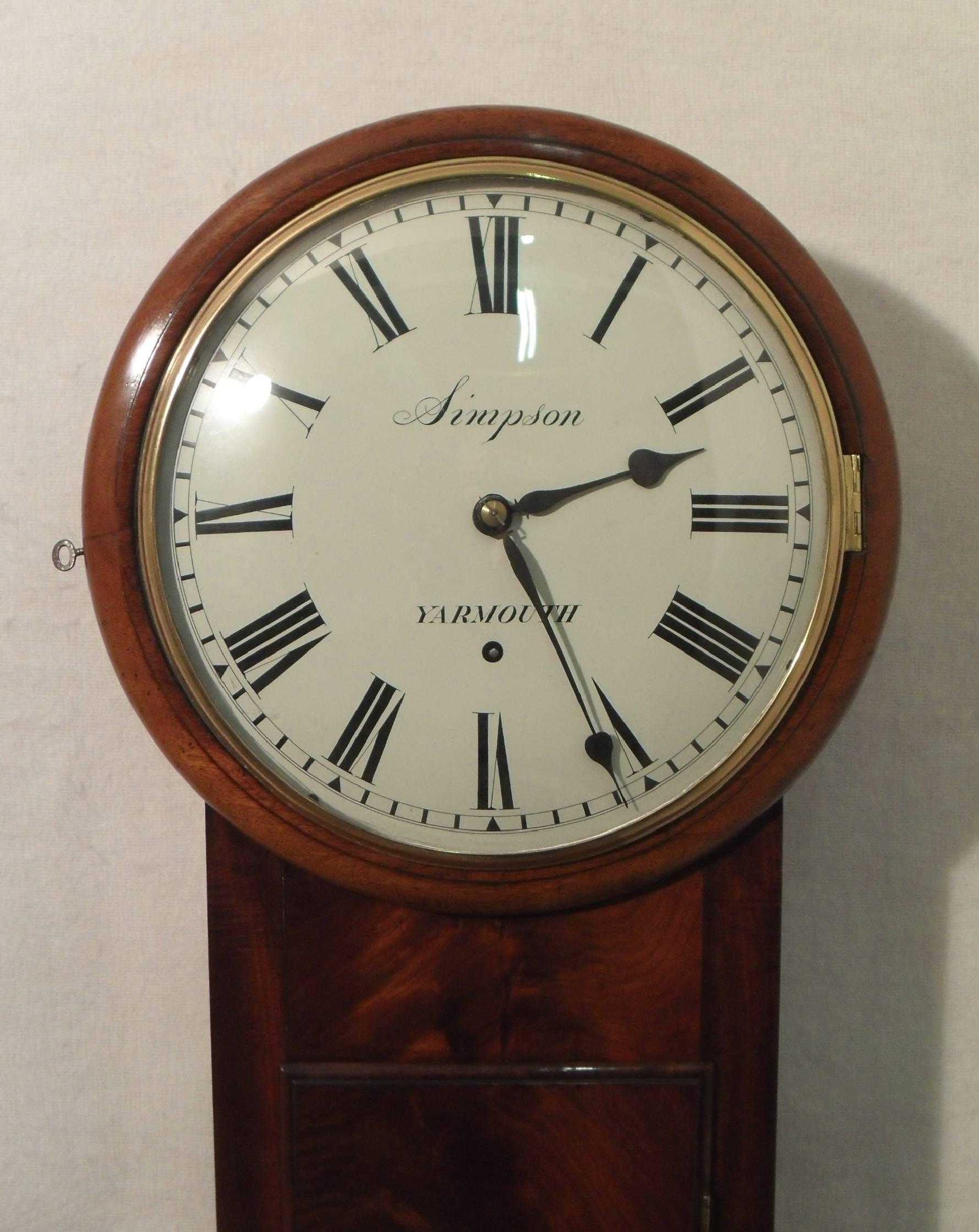 ​A superb quality figured mahogany George IV Norfolk wall clock timepiece with a weight driven eight day movement, anchor escapement and anti clockwise winding mechanism with  'A' shaped front and back plates to the movement.

The clock has a 12
