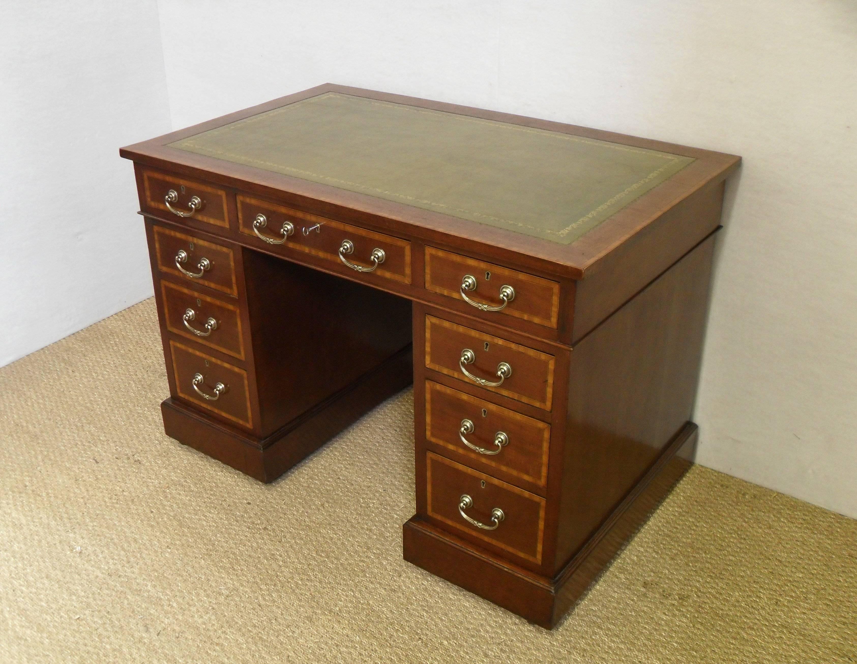 A very good quality Edwardian mahogany pedestal writing desk with satinwood and boxwood string inlay. All the drawers are made of mahogany. The top is fitted with a green hide and gold tooled leather.

Knee hole measurements:-
Height 23.5