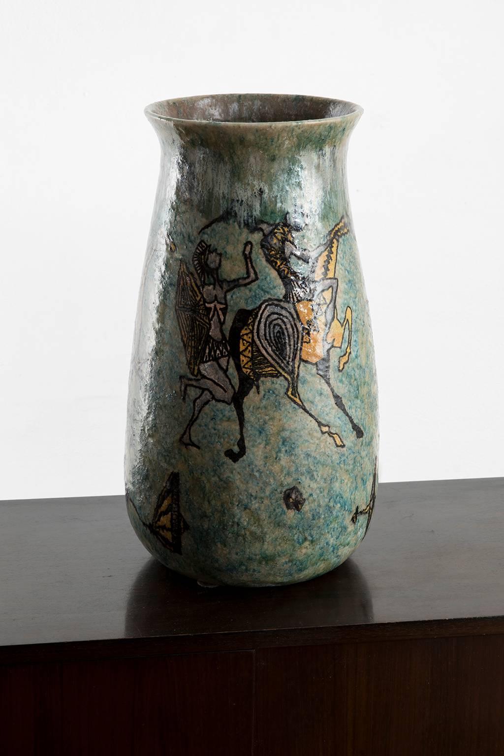 Monumental mythology themed vase created by the ceramist and sculptor Carlo Zauli in the early 1950s. Turquoise glaze in the background with magnificent Greek warriors fighting.
Signed 'Zauli Faenza' on the bottom.

Carlo Zauli (Faenza, 1926-2002)