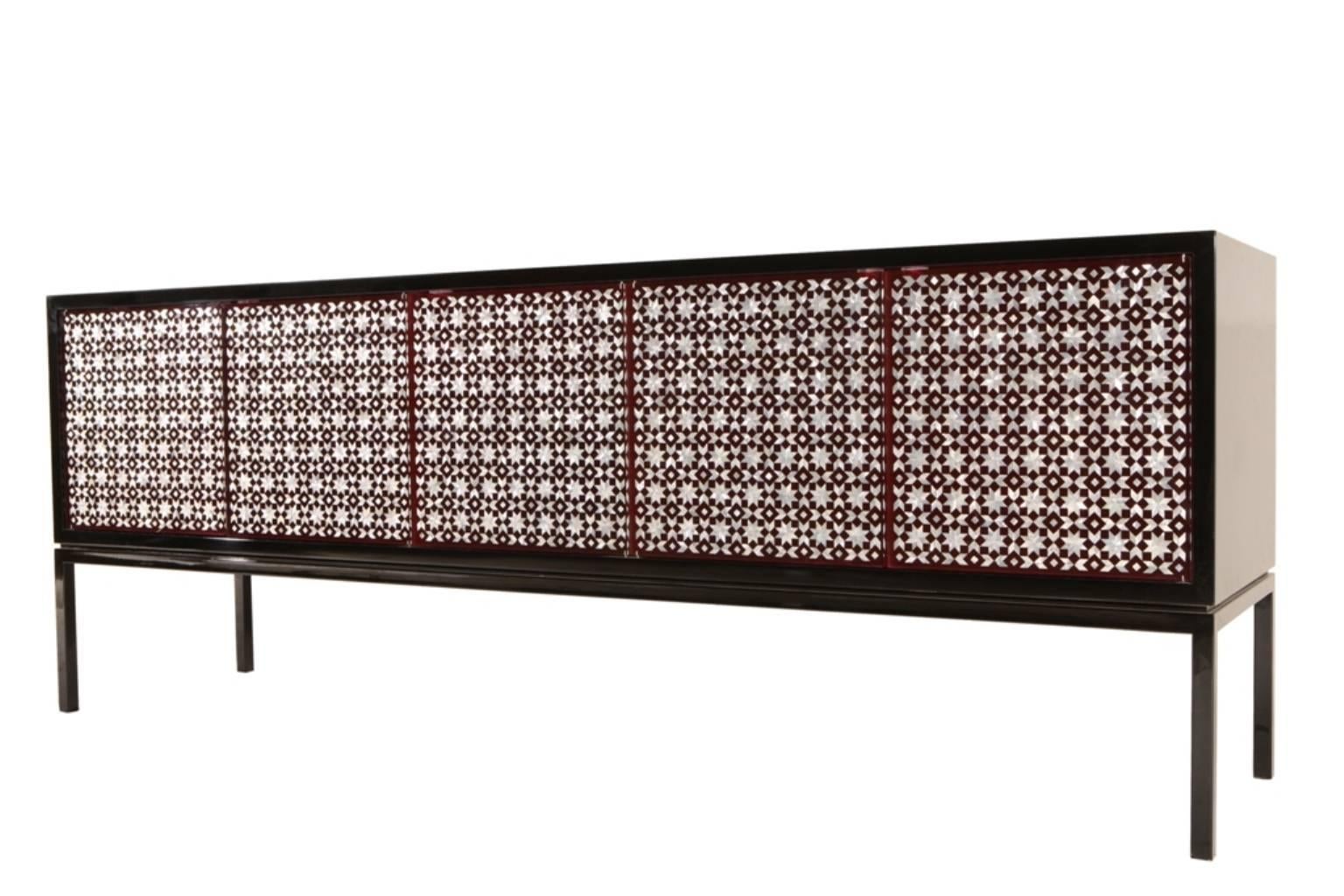 Le Grand Buffet cabinet sits with carefully balanced proportion on a steel frame. Body is walnut in wood finishes or lacquer colors. Traditional technique is used to inlay mother-of-pearl into plexiglas doors, obscuring storage contents while still