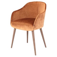Curvy Dining Armchair Offered in Several Upholstery Options and Wood Leg Colors