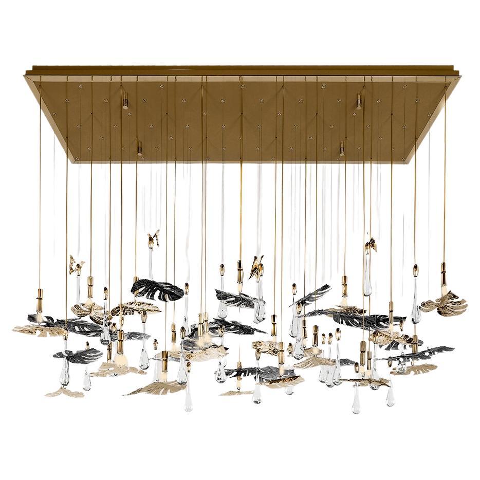 Inspired by the serene beauty of a rainforest, this suspended chandelier features handcrafted, gold-plated brass leaves paired with crystal accents. Each element is meticulously designed to evoke the organic elegance of nature, with a cascading