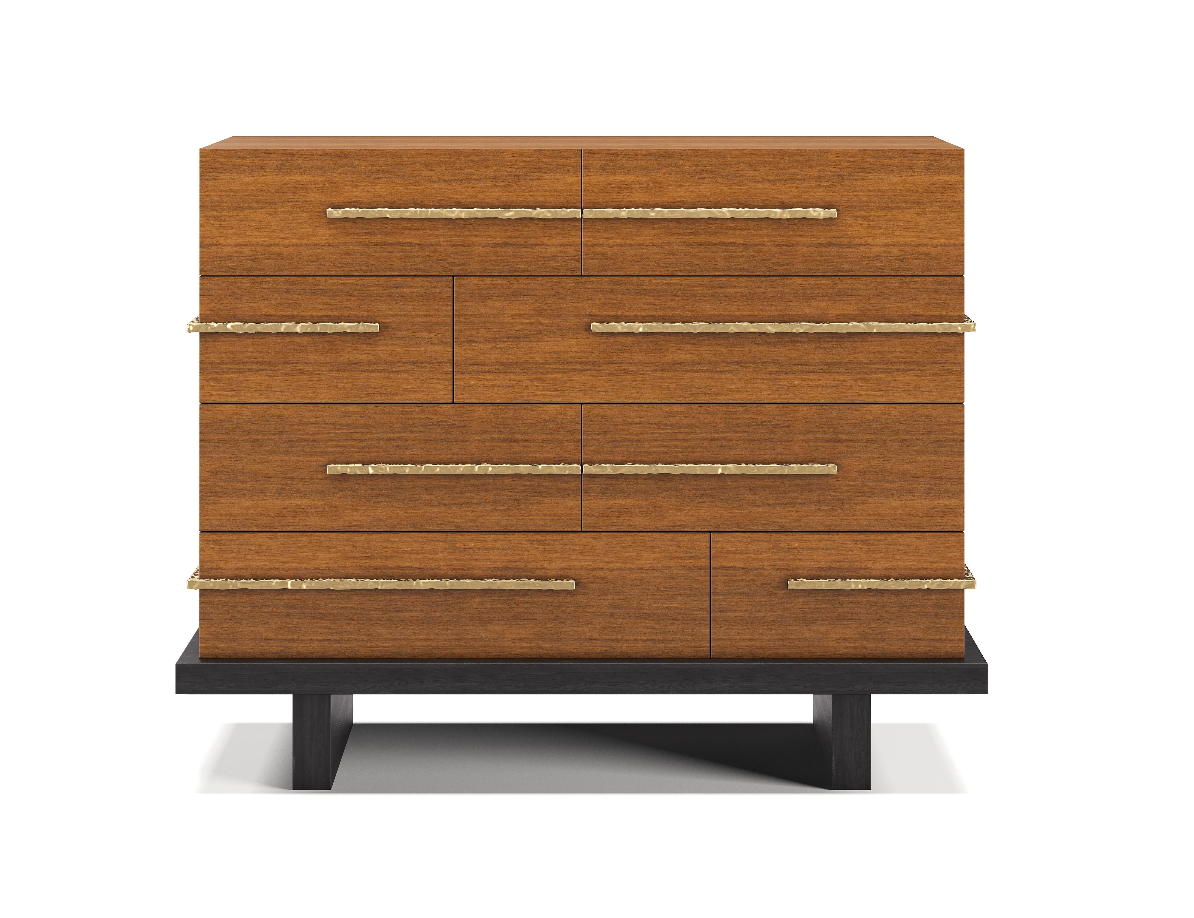 A contemporary chest of drawers featuring multiple horizontal drawers arranged in an irregular stacked composition.

Hammered brass rod handles slice through the body in stratified bands, wrapping around the sides to emphasize the layered