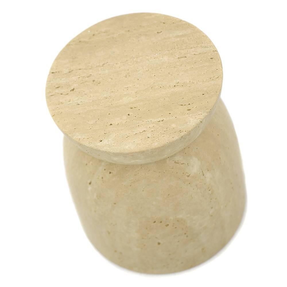 Upon first glace, one can see that the Japan Table is the personification of a cork. Designed as a table or a stool, this version of the Japan is made in solid travertine marble. The piece features pure lines, or veins, documenting the pure and