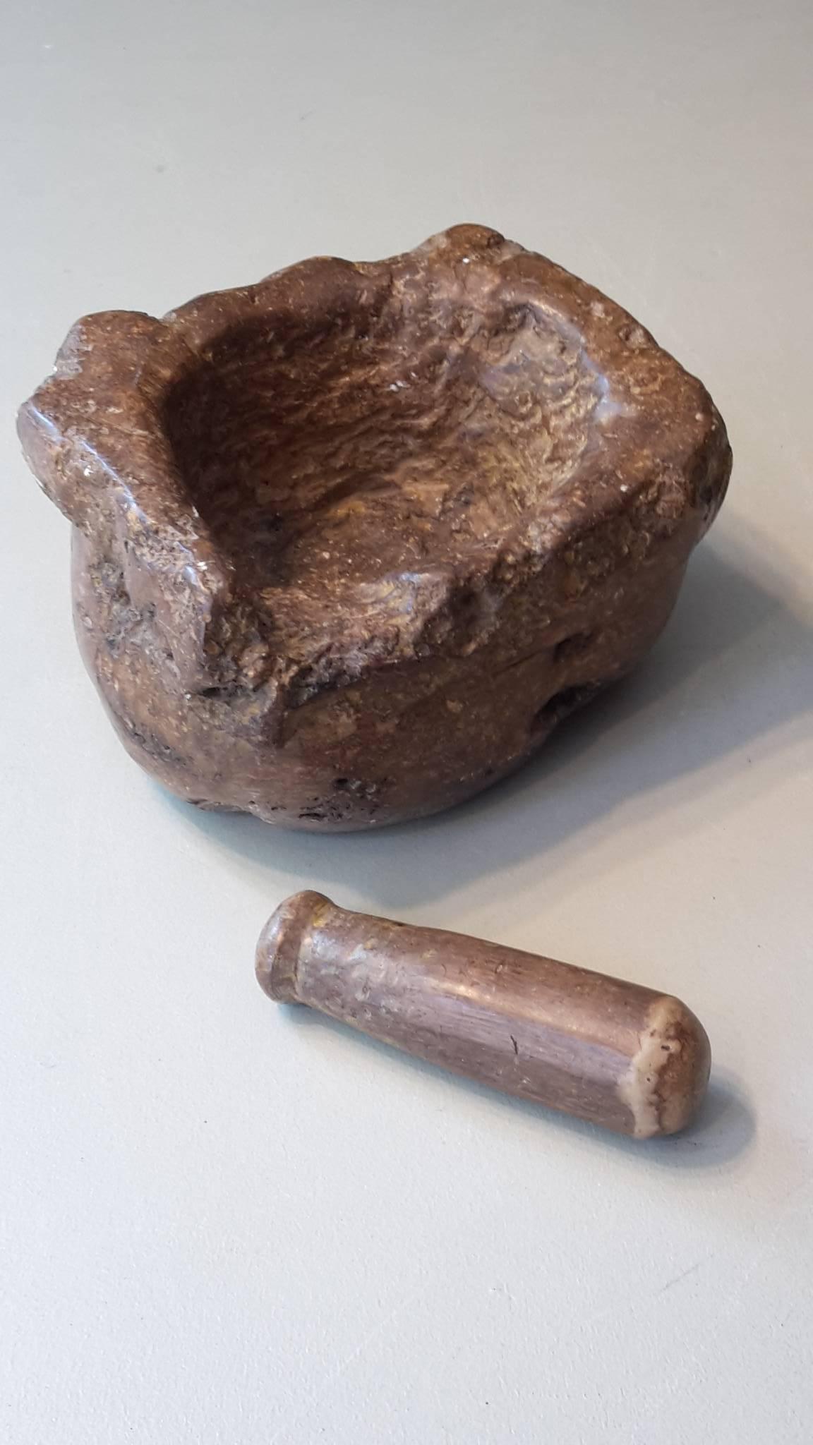 Early 20th century mortar and pestle made of stone.