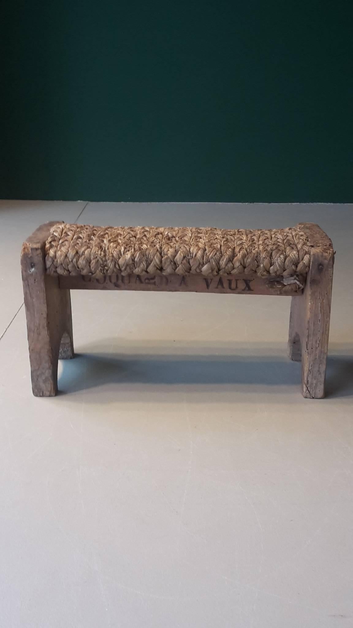 Early 19th century footstool made of straw and wood. Name of the property burned with iron on the edge.