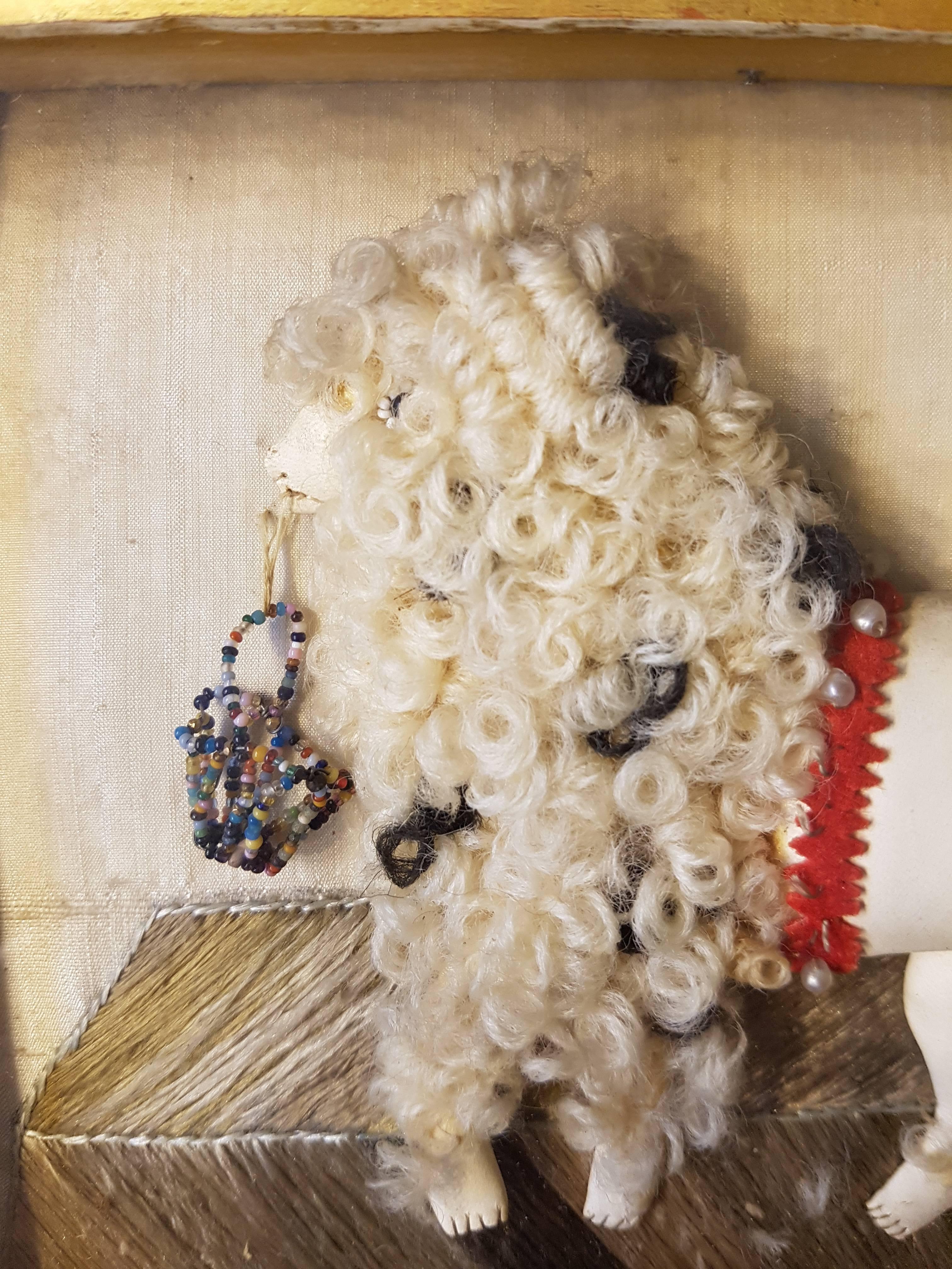 Late 19th century French framed curiosity: poodle made of leather, wool and pearls sewn on silk.