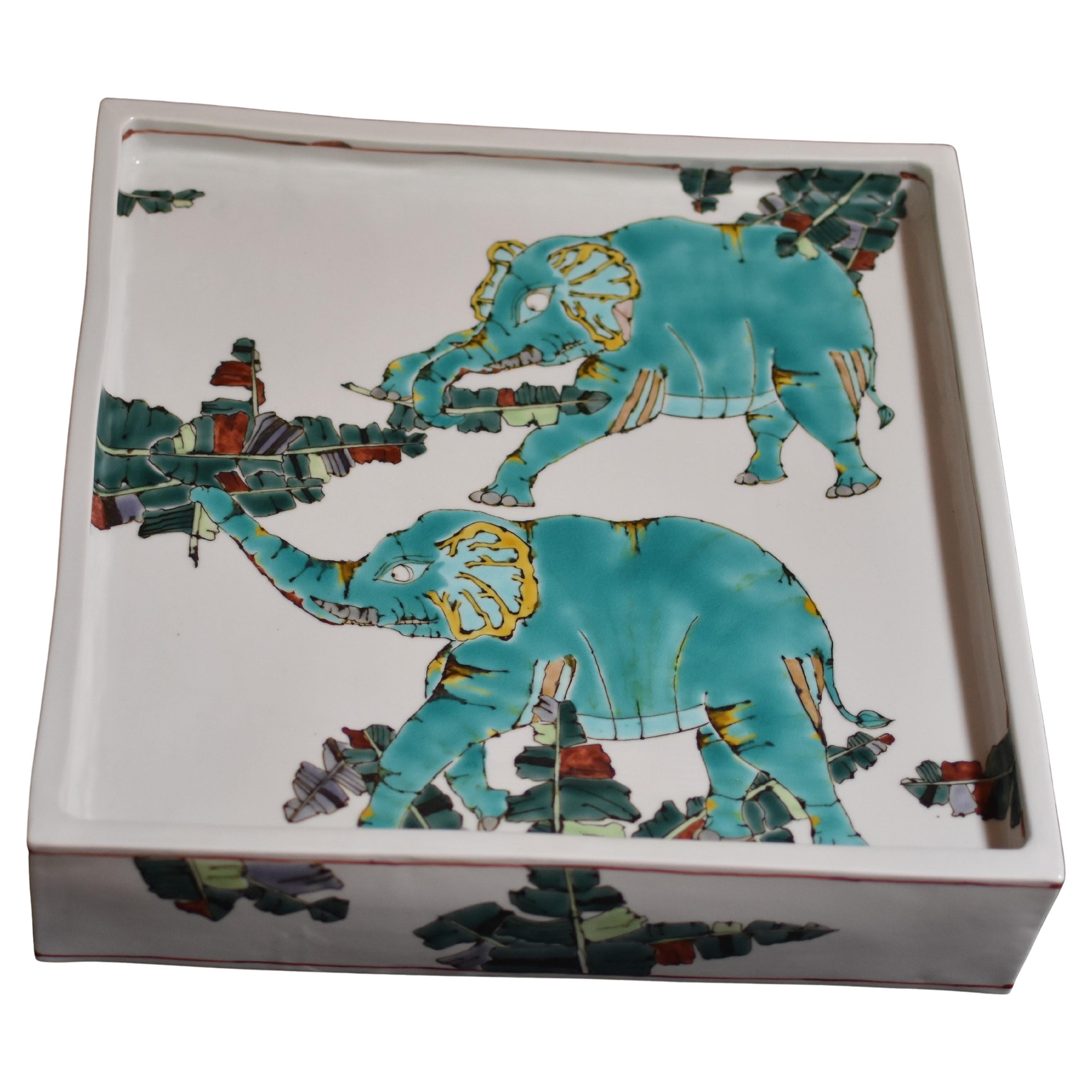 Exceptional contemporary Japanese museum-quality porcelain charger/centrepiece, hand-painted in the artist's signature green and turquoise on a stunningly shaped raised square body, with a unique interpretation of elephants. It is a signed